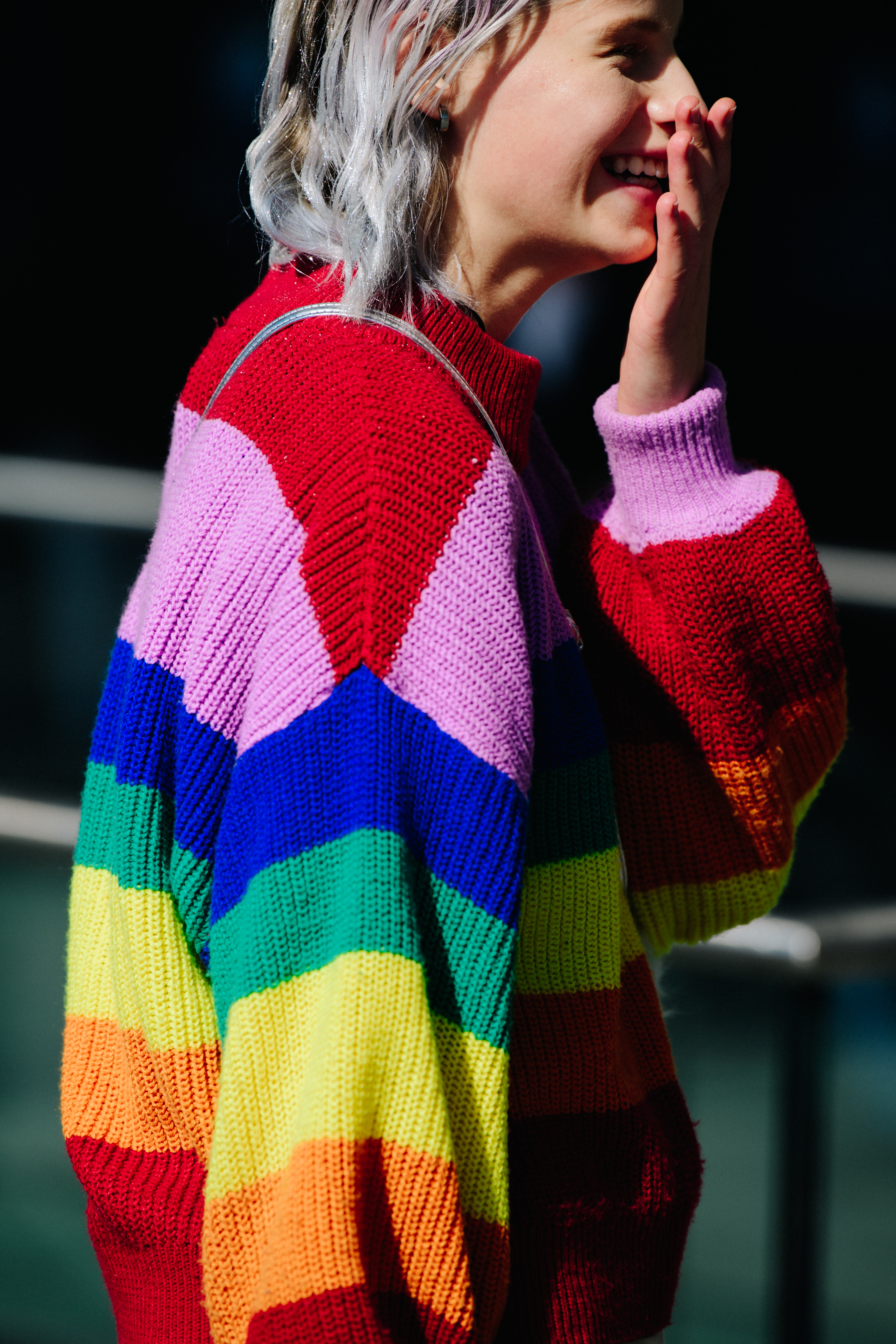 Woman wearing colourful striped jumper