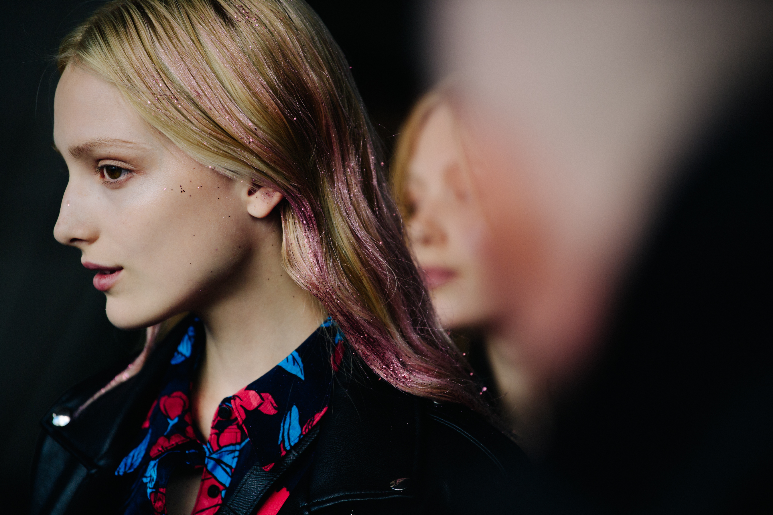 Model wearing pink glitter in hair