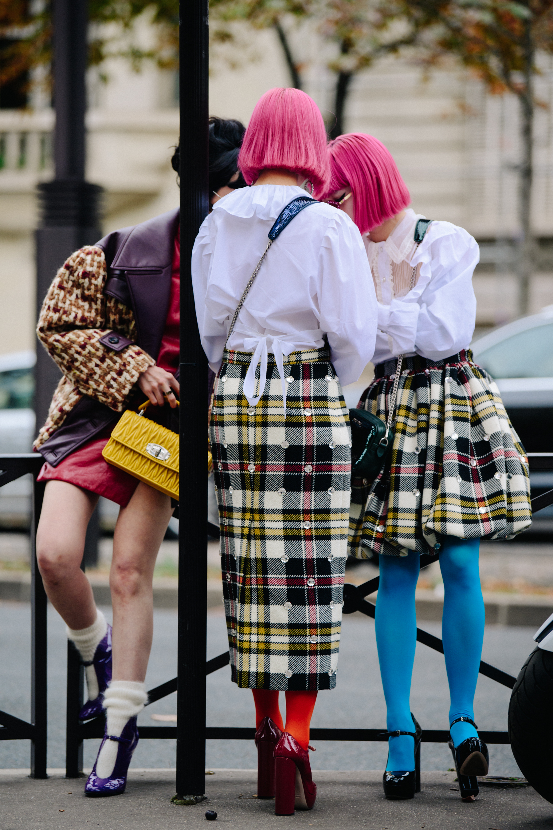 Three women wearing colourful shoes