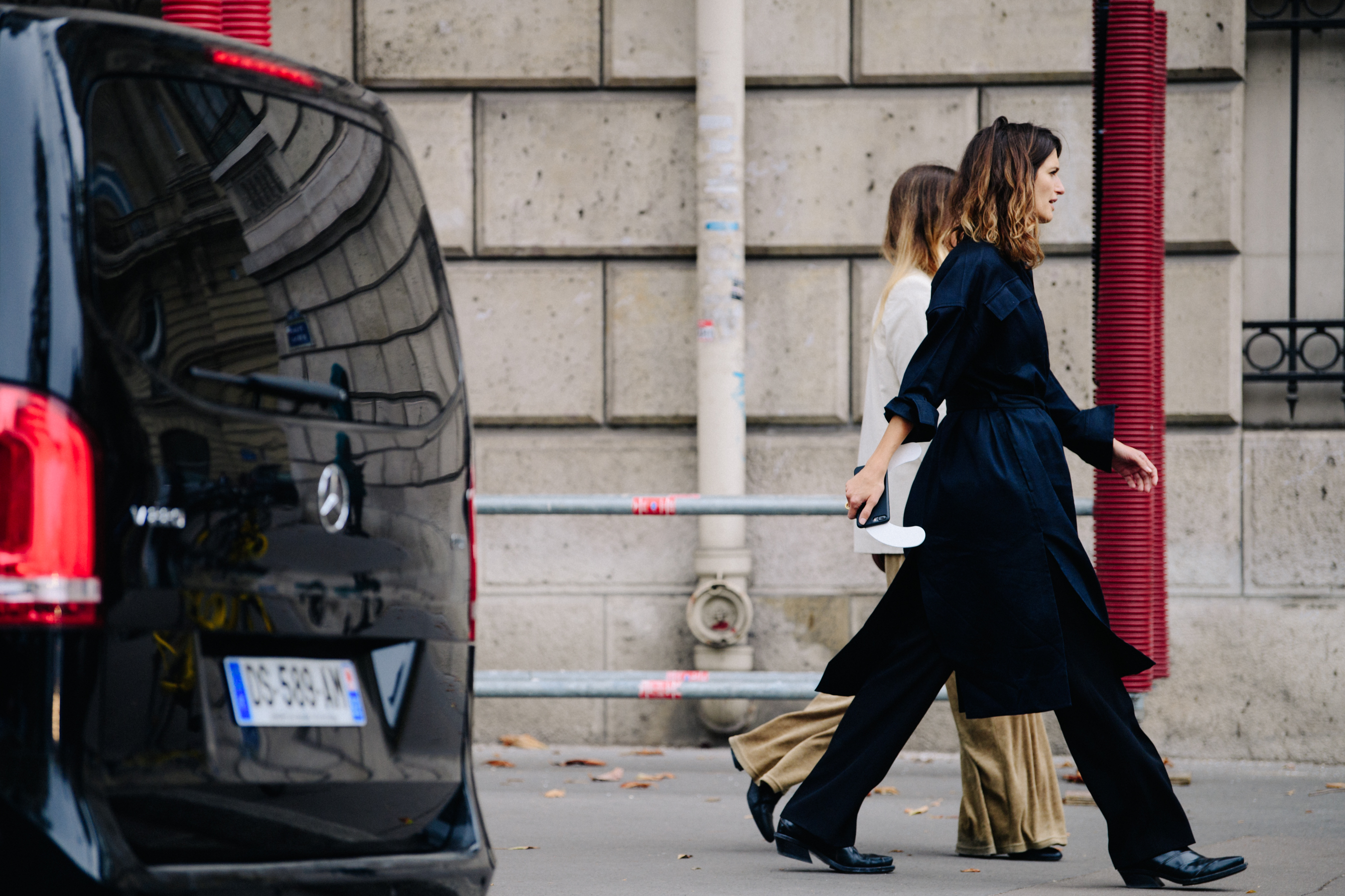 Two women wearing dark and light outfits