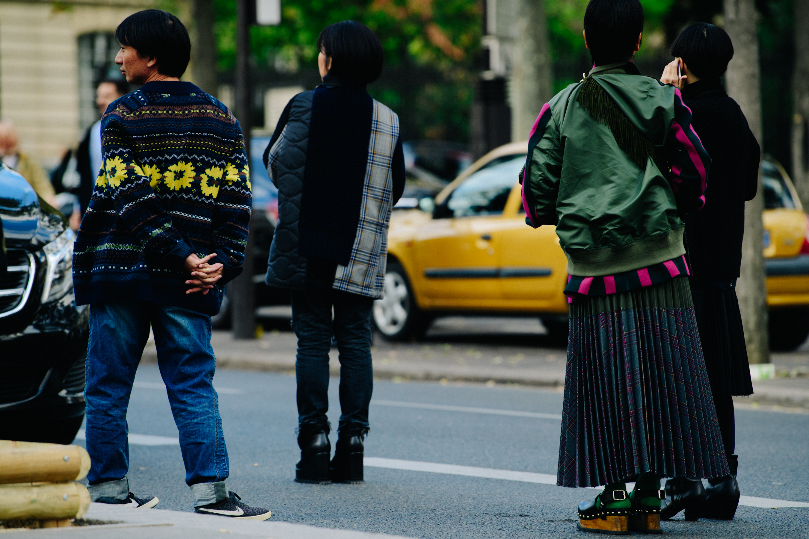 Four people wearing colourful outfits