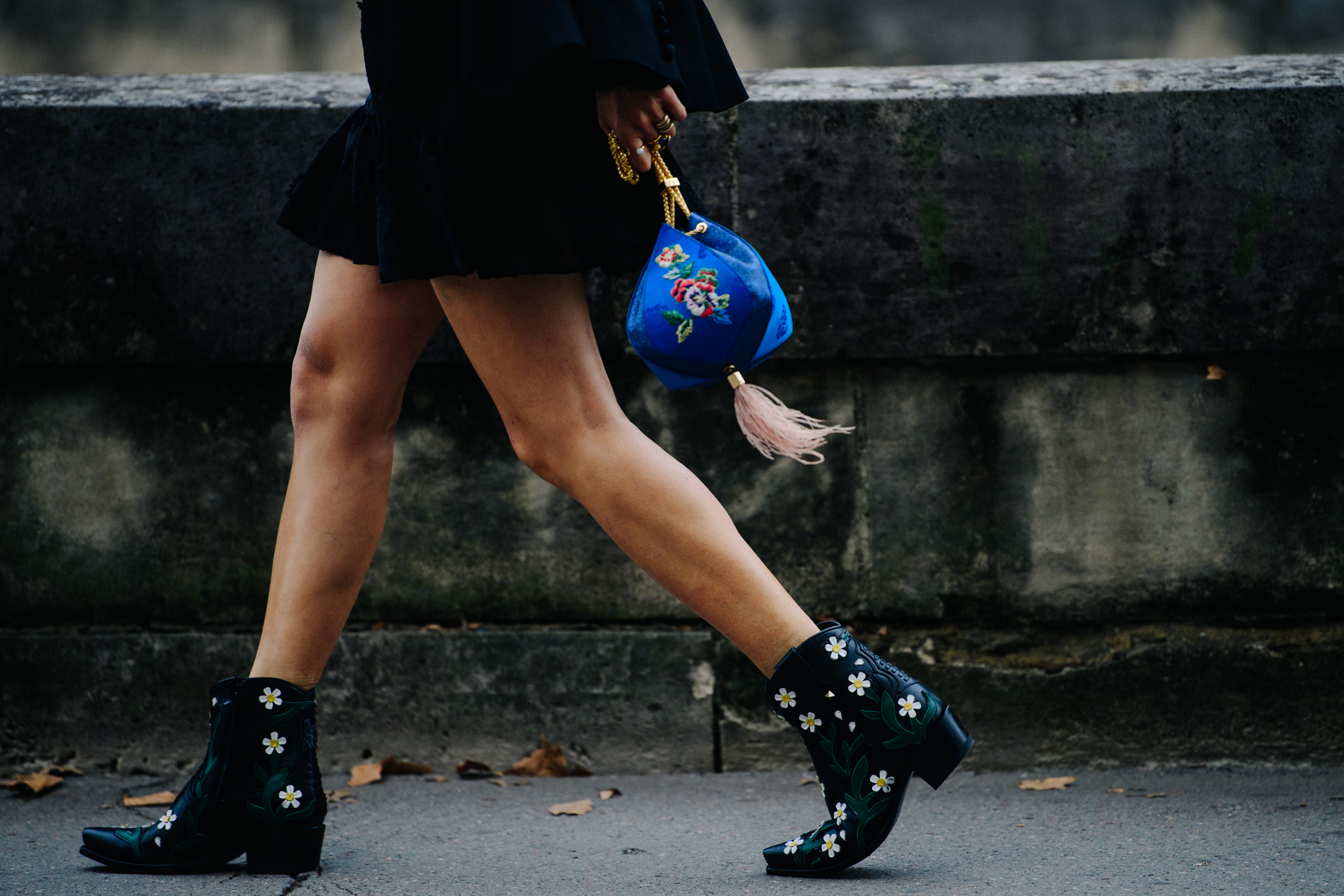 Woman carrying small blue bag