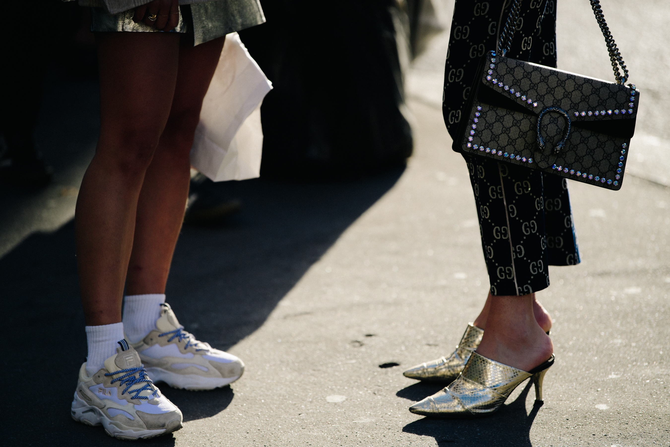 Two women wearing designer shoes