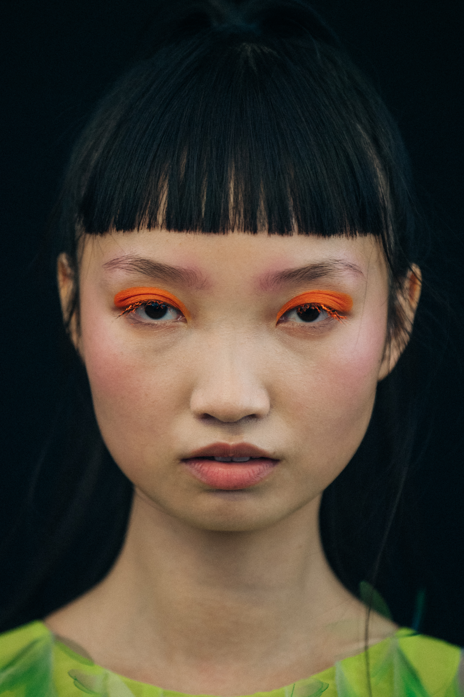Portrait of model wearing colourful eyeliner
