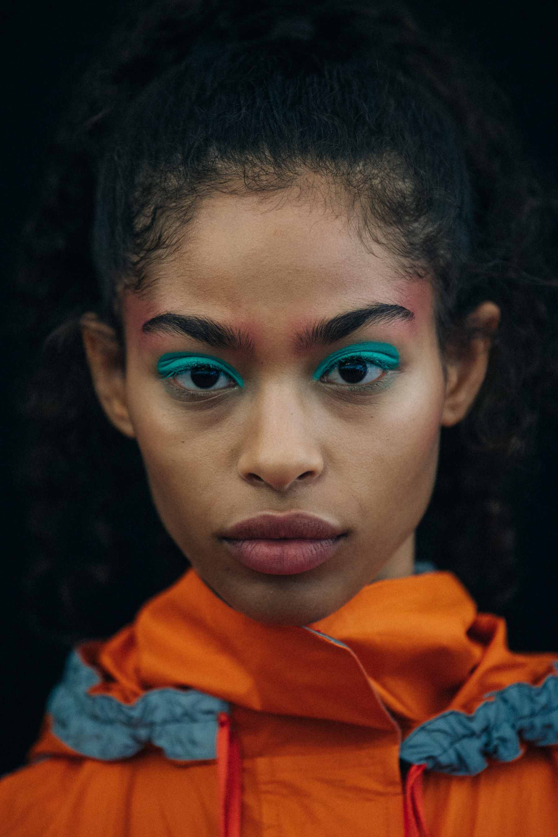 Portrait of model wearing colourful eyeliner