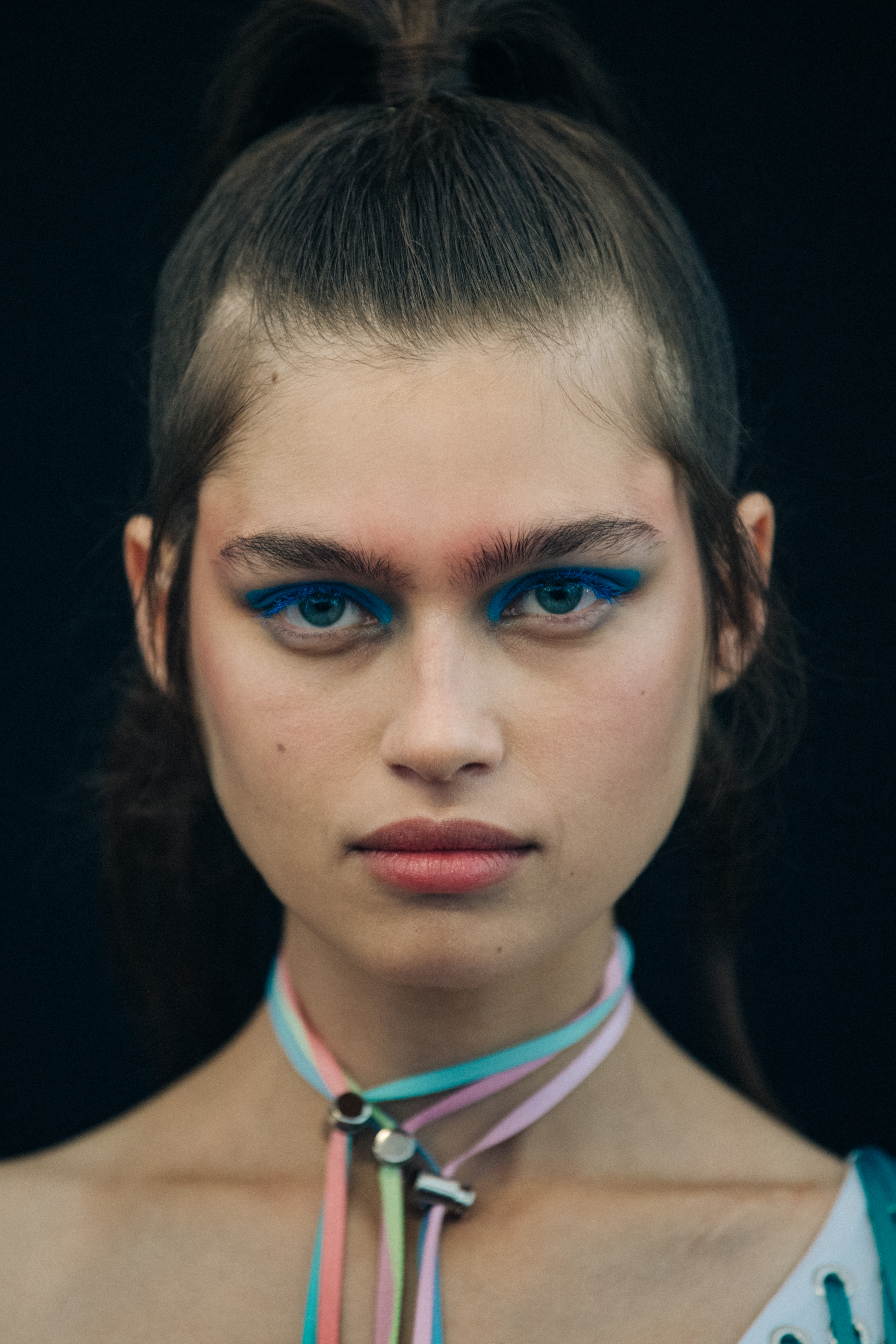 Portrait of model wearing colourful eyeliner