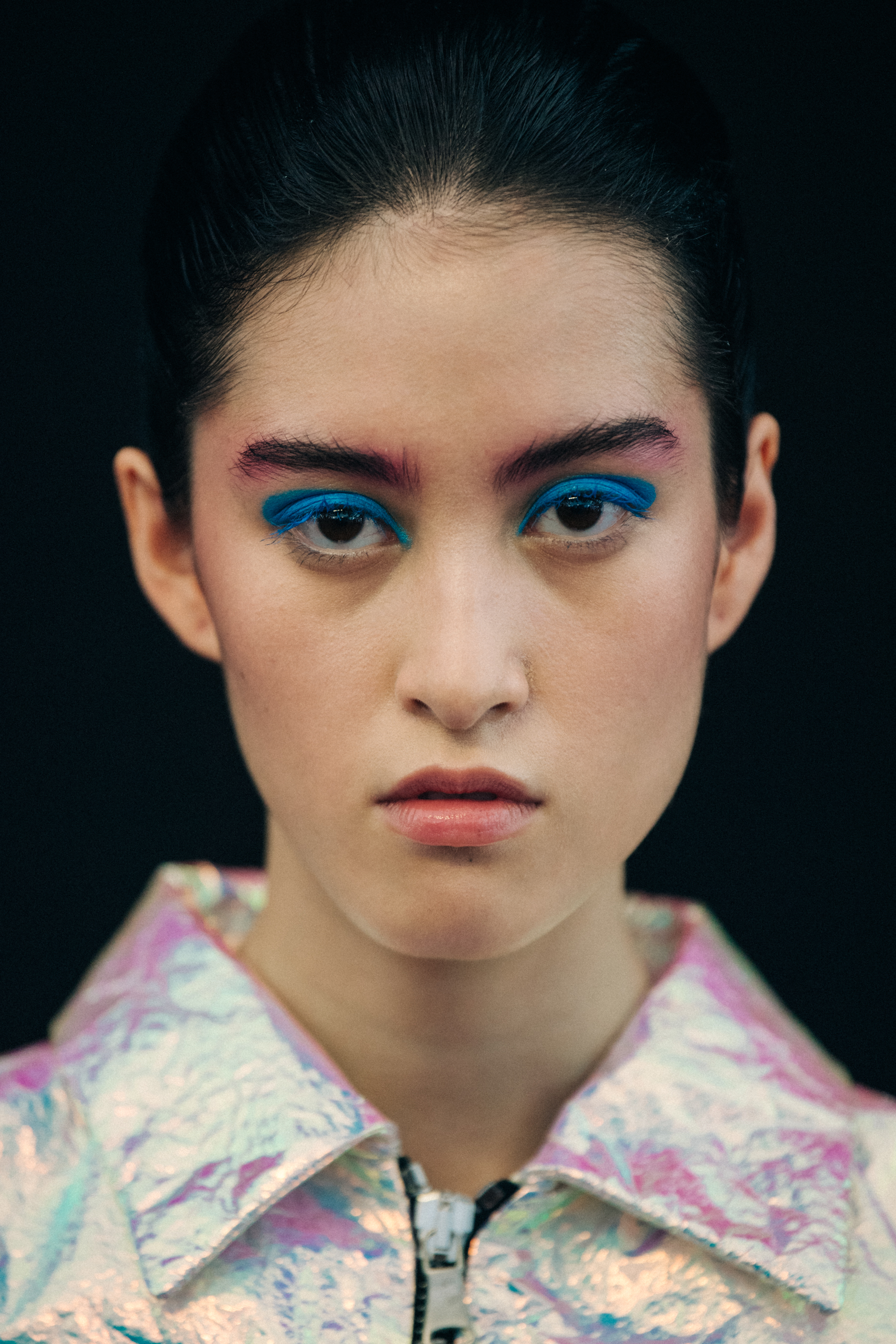 Portrait of model wearing colourful eyeliner