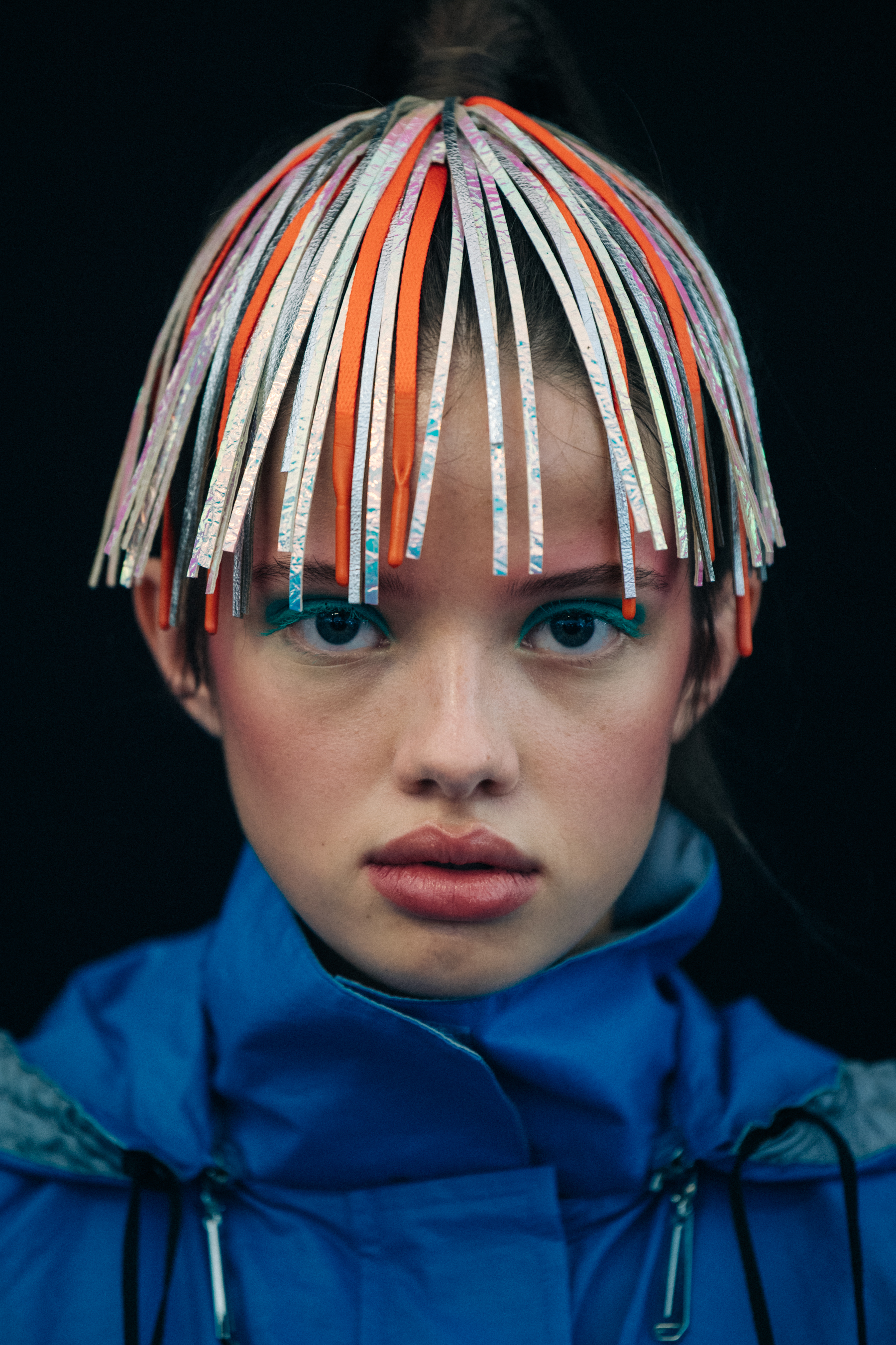 Portrait of model wearing colourful headpiece