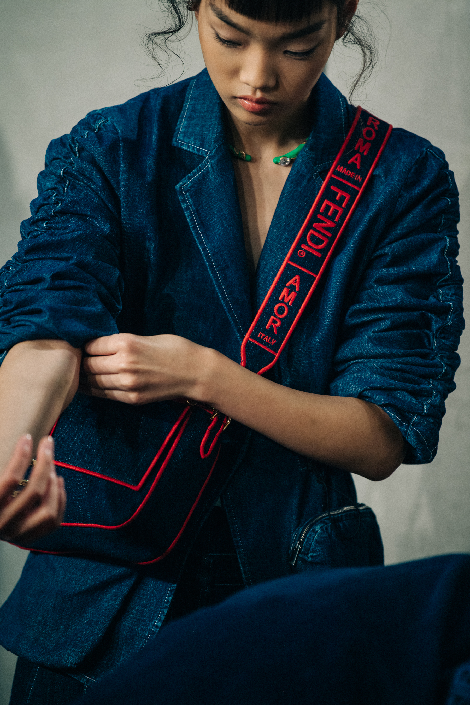 Model carrying denim Fendi bag