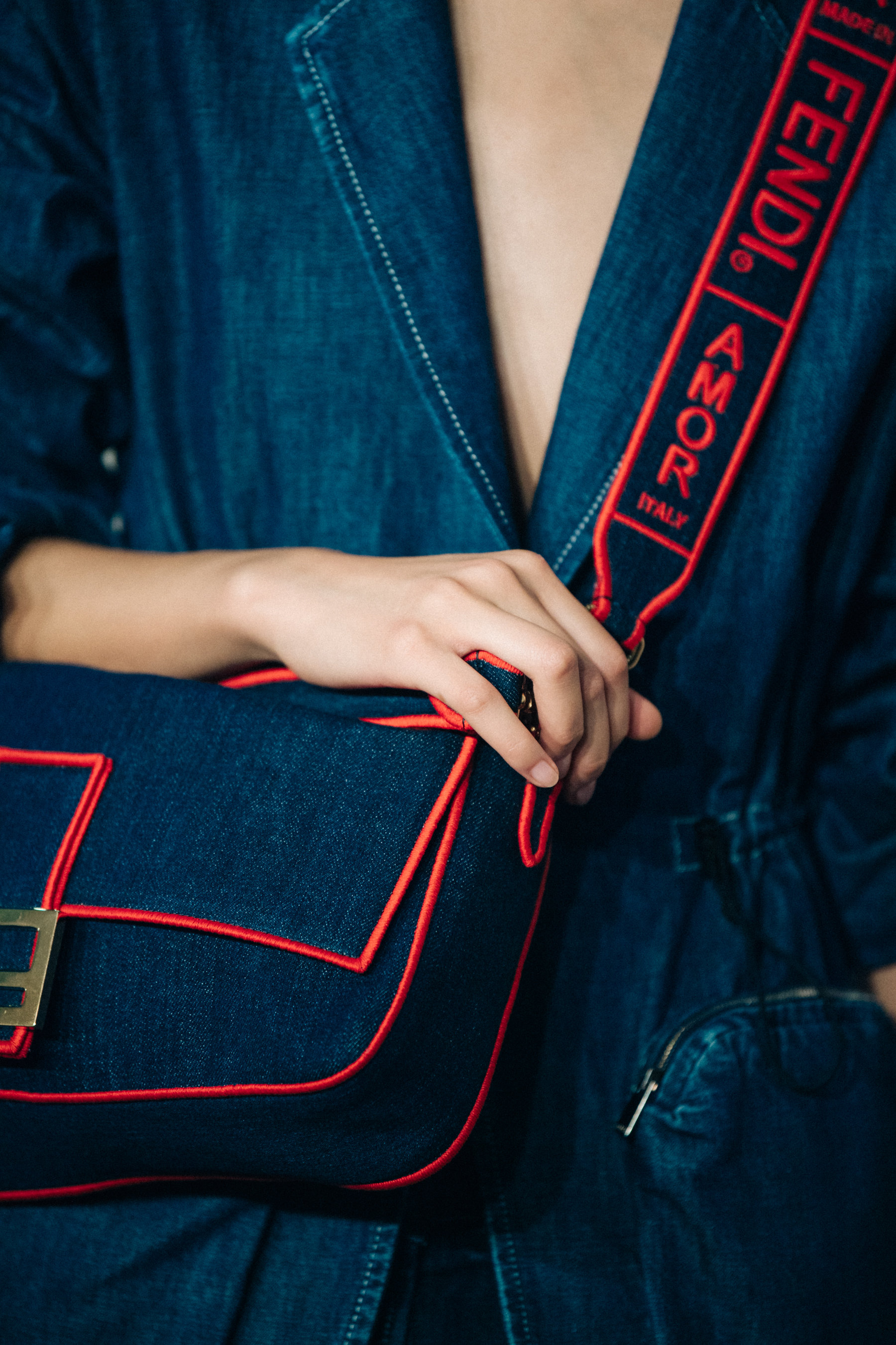 Model carrying denim Fendi bag
