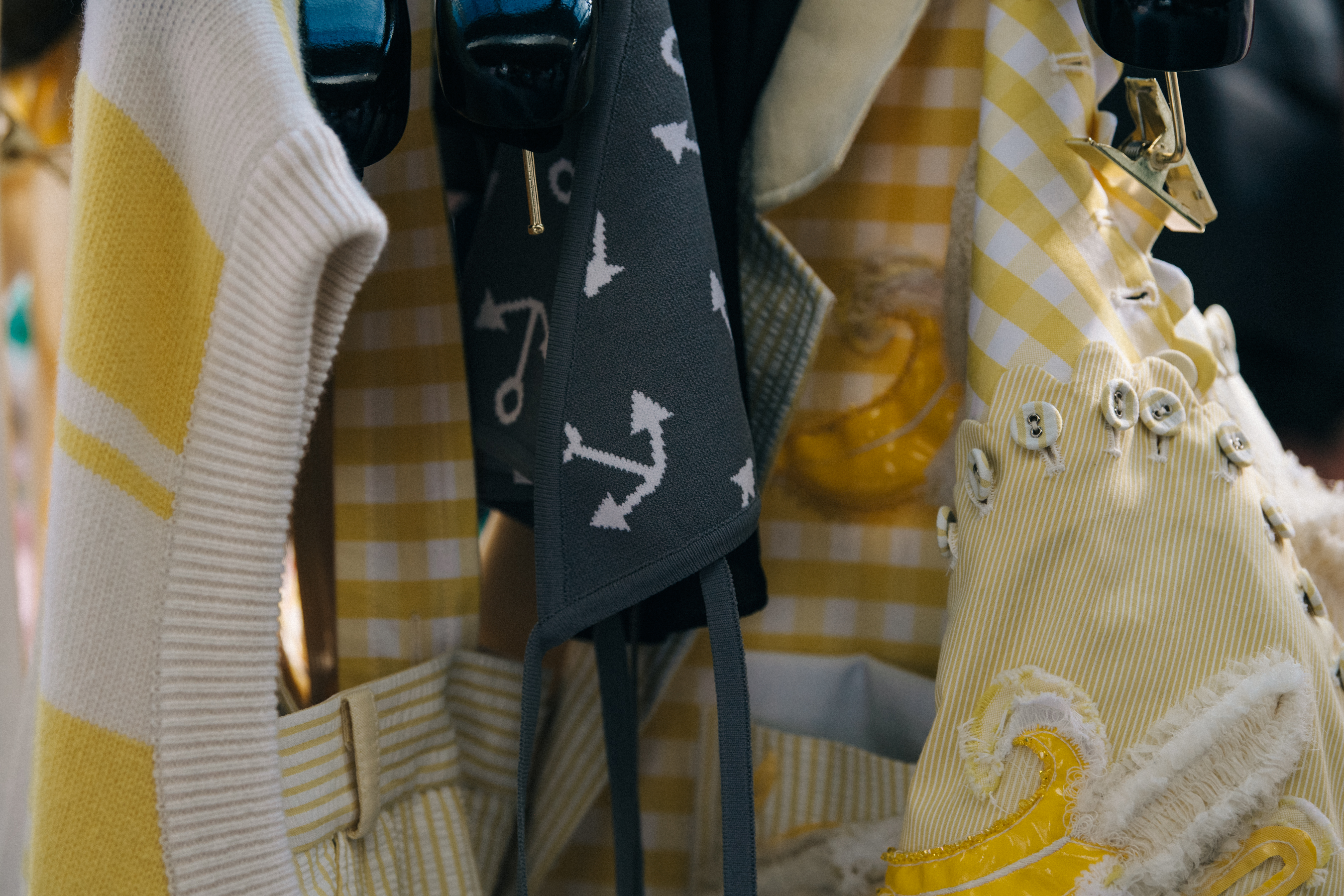 Thom Browne clothes hanging backstage