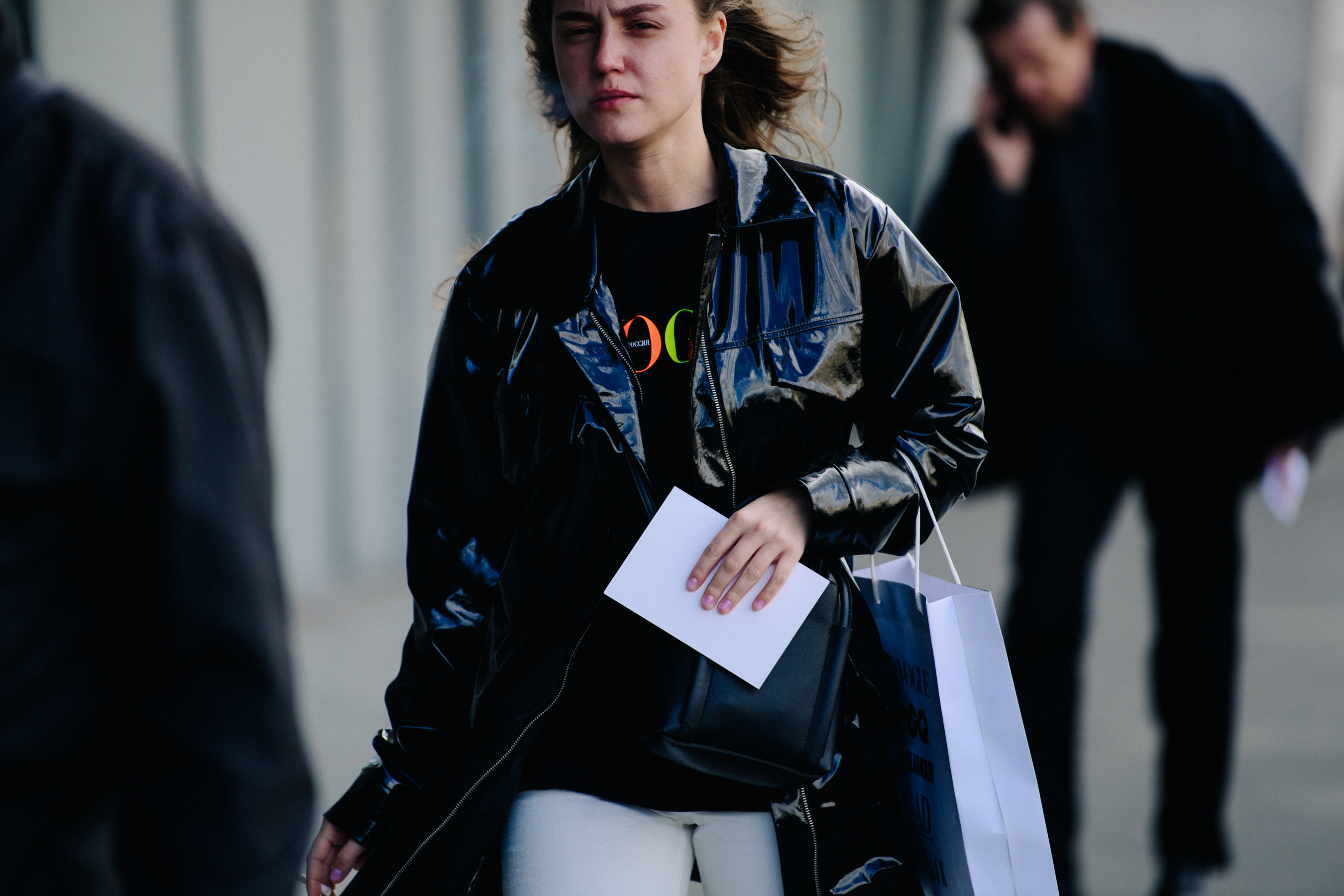 Woman wearing black plastic jacket