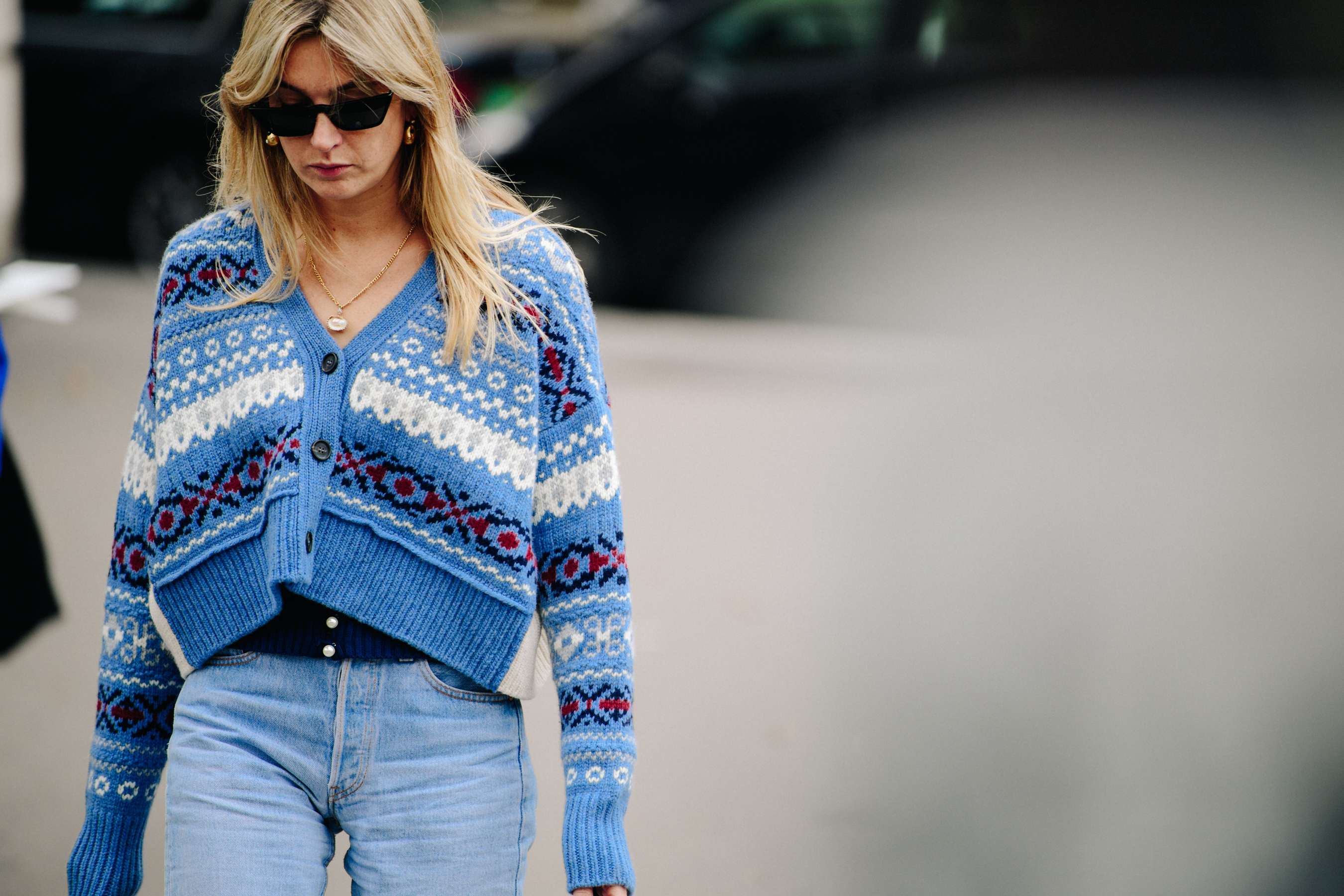 Woman wearing blue knit cardigan