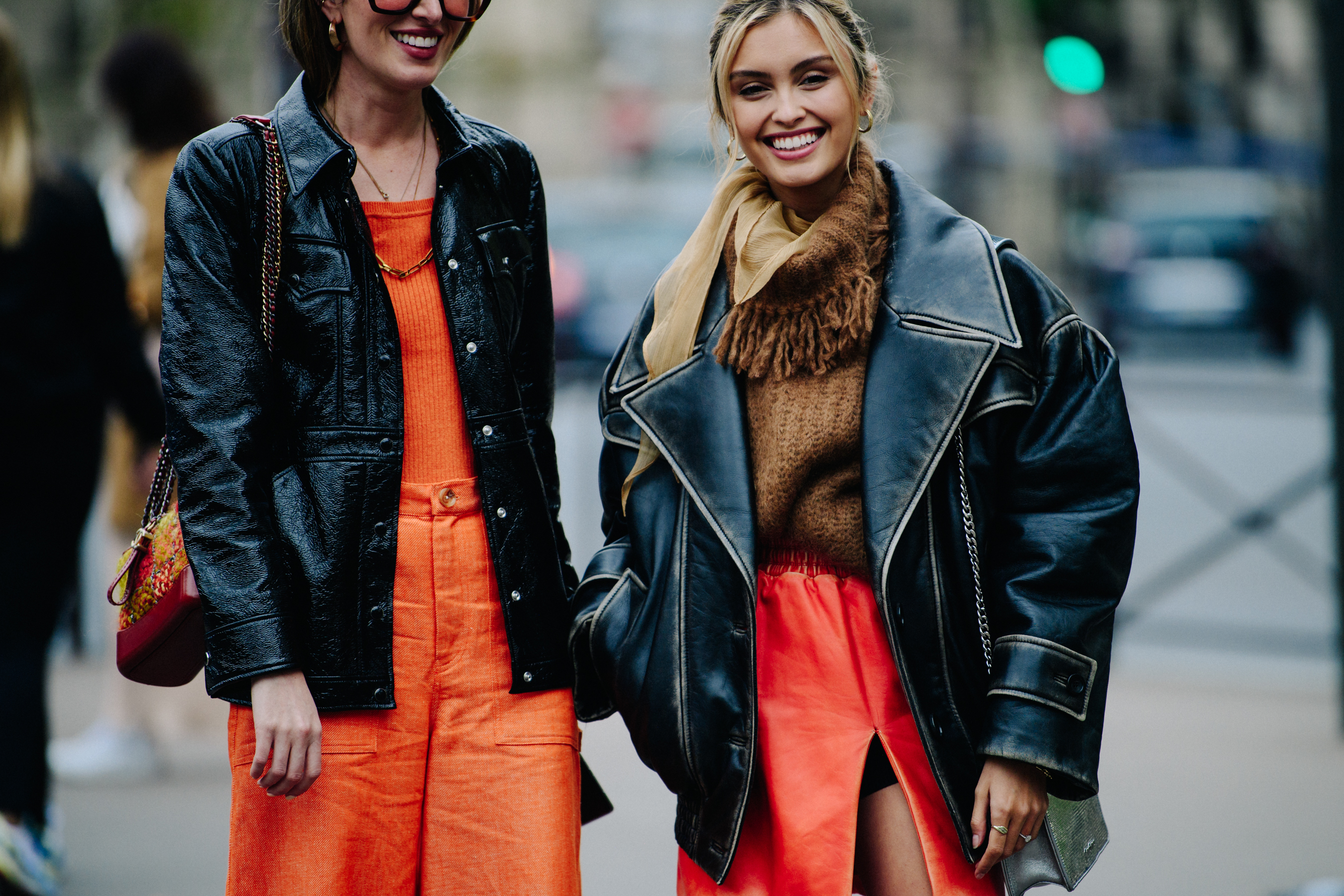 Two women wearing orange