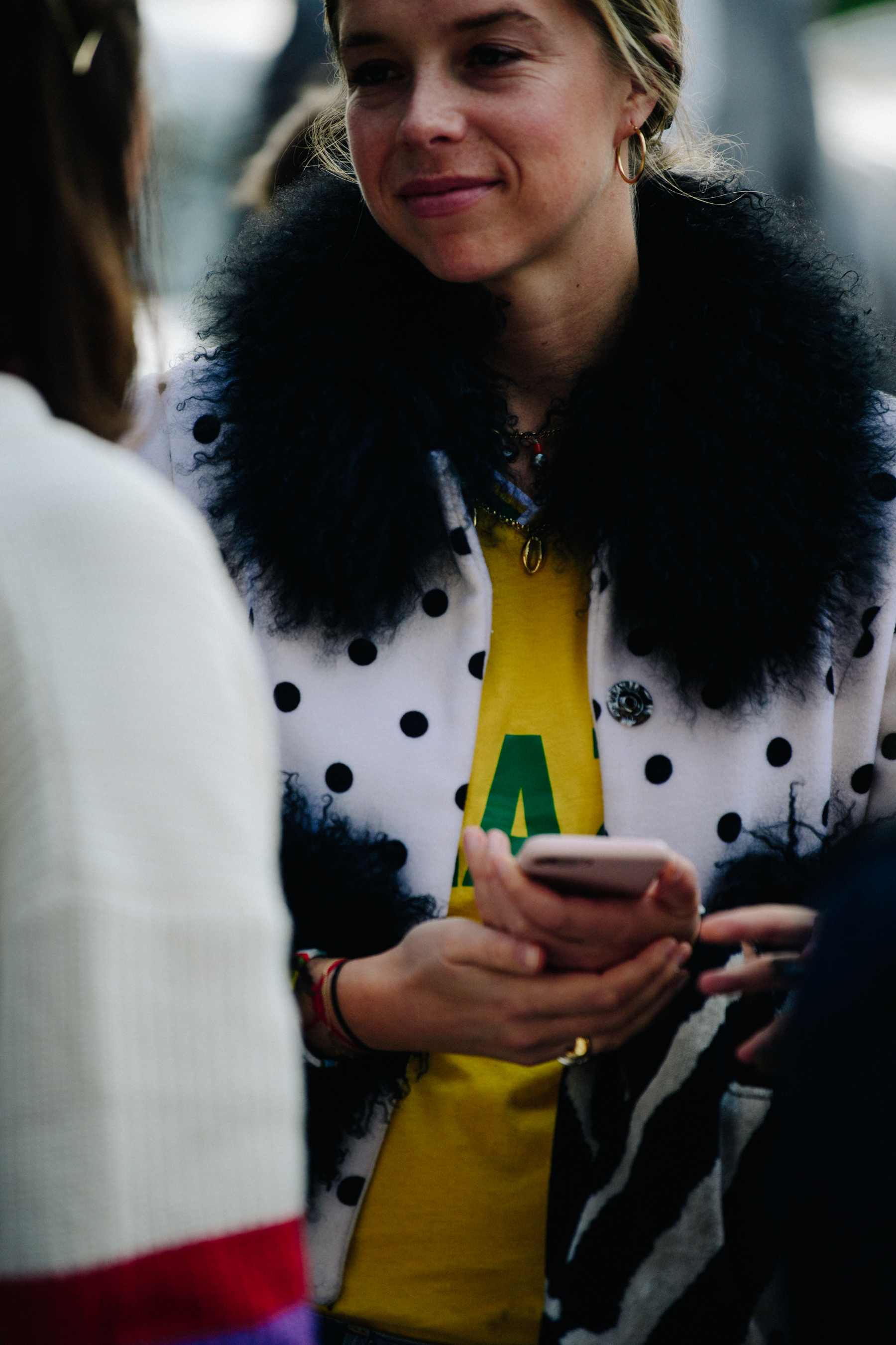 Woman wearing white spotted jacket