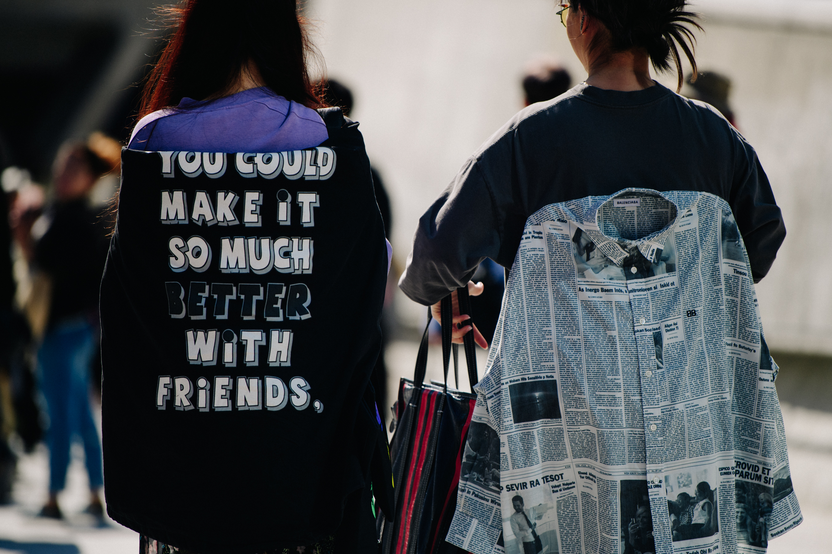 Two women wearing back patterns