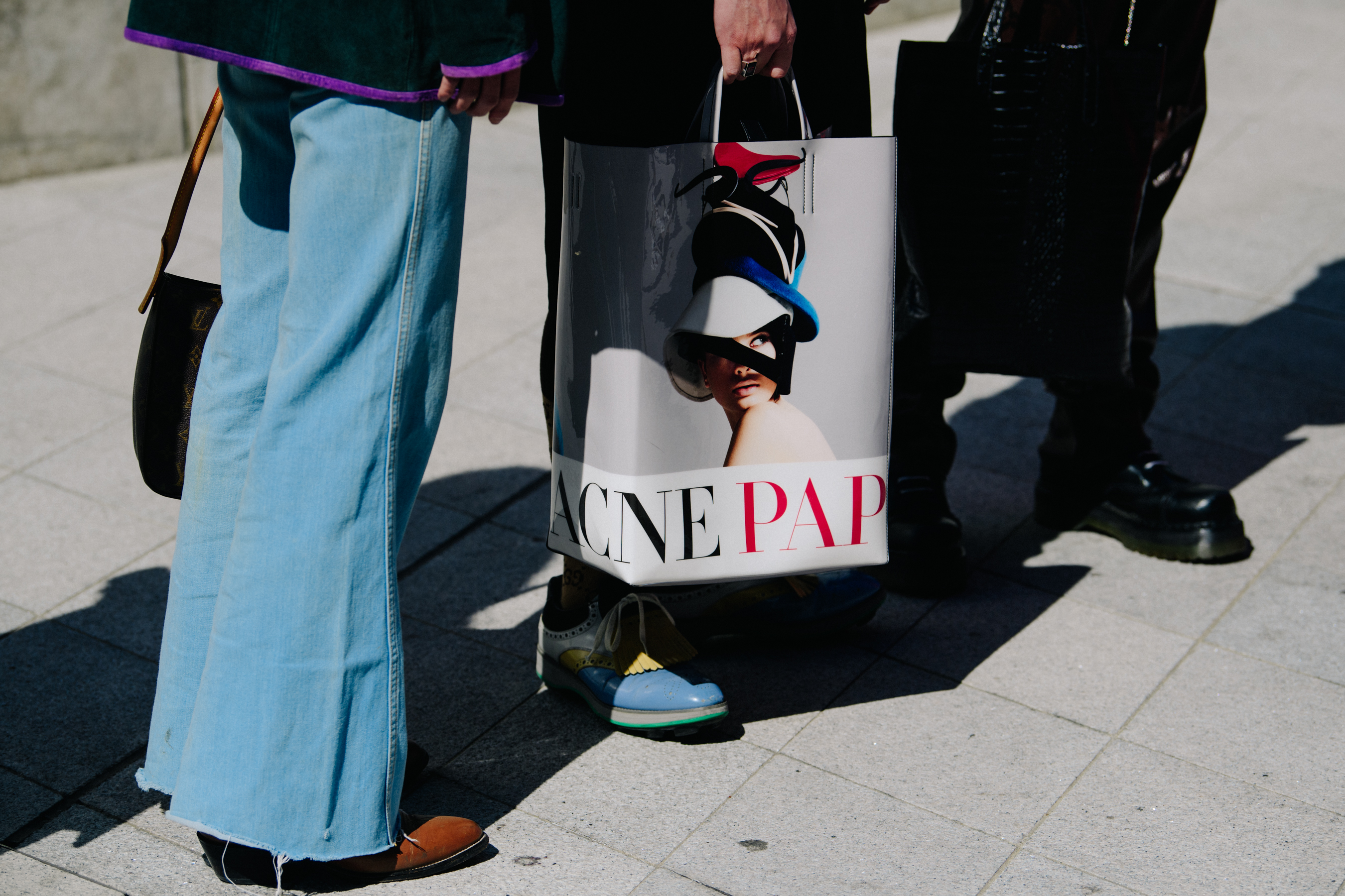 Man carrying Acne paper bag