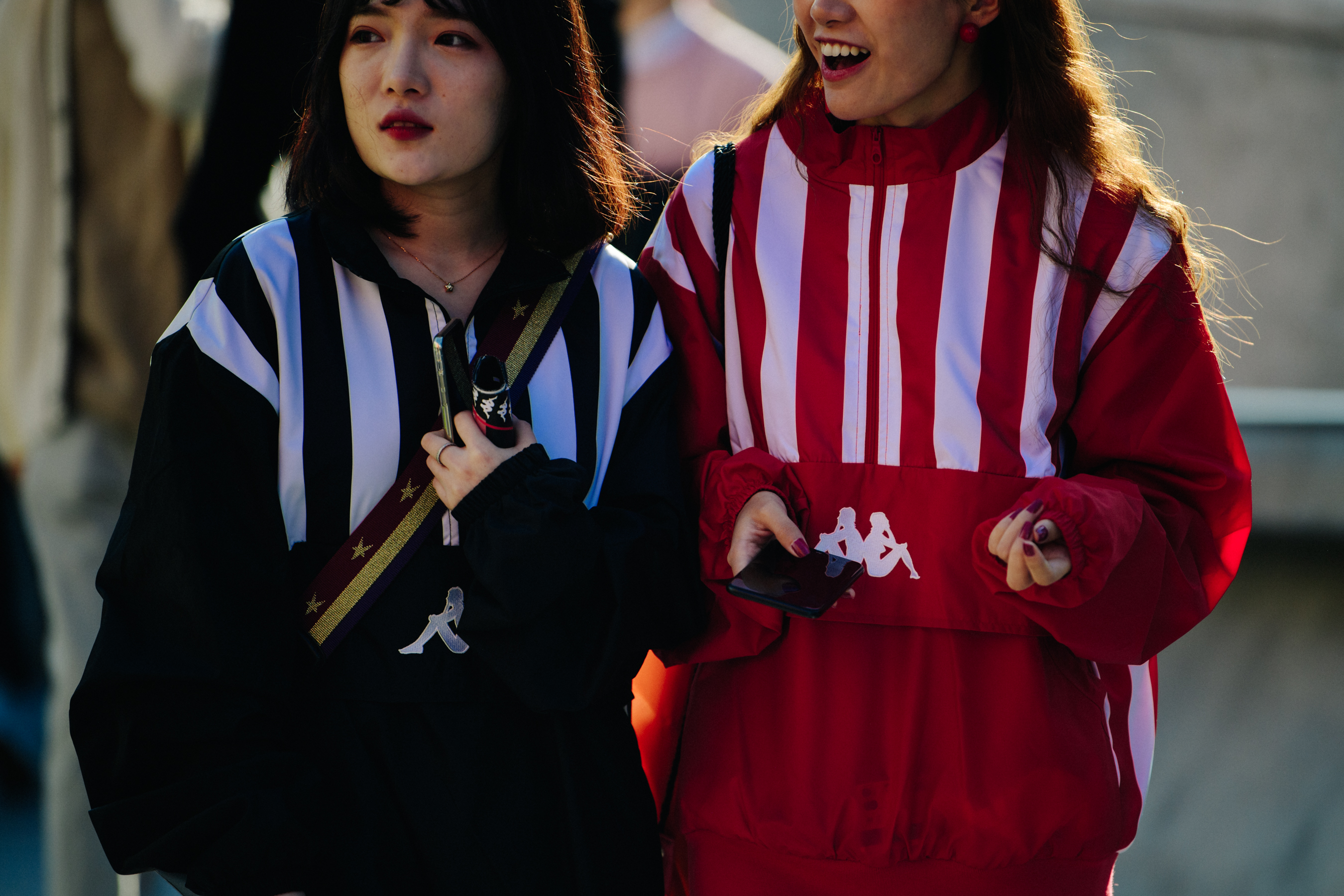 Two women wearing colourful striped outfits