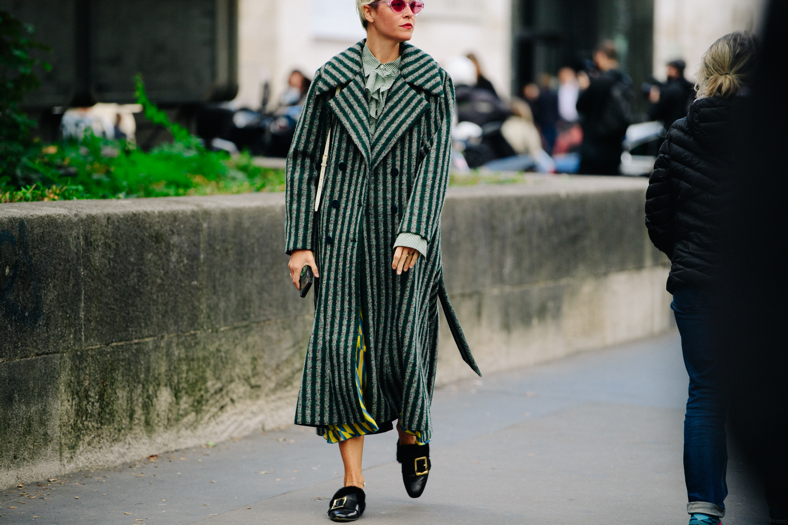 Woman wearing long striped coat
