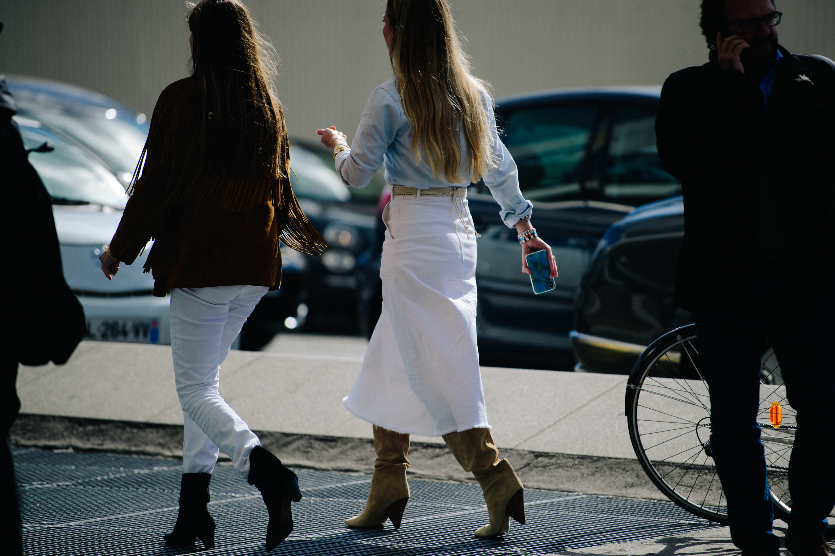 Two women wearing white denim