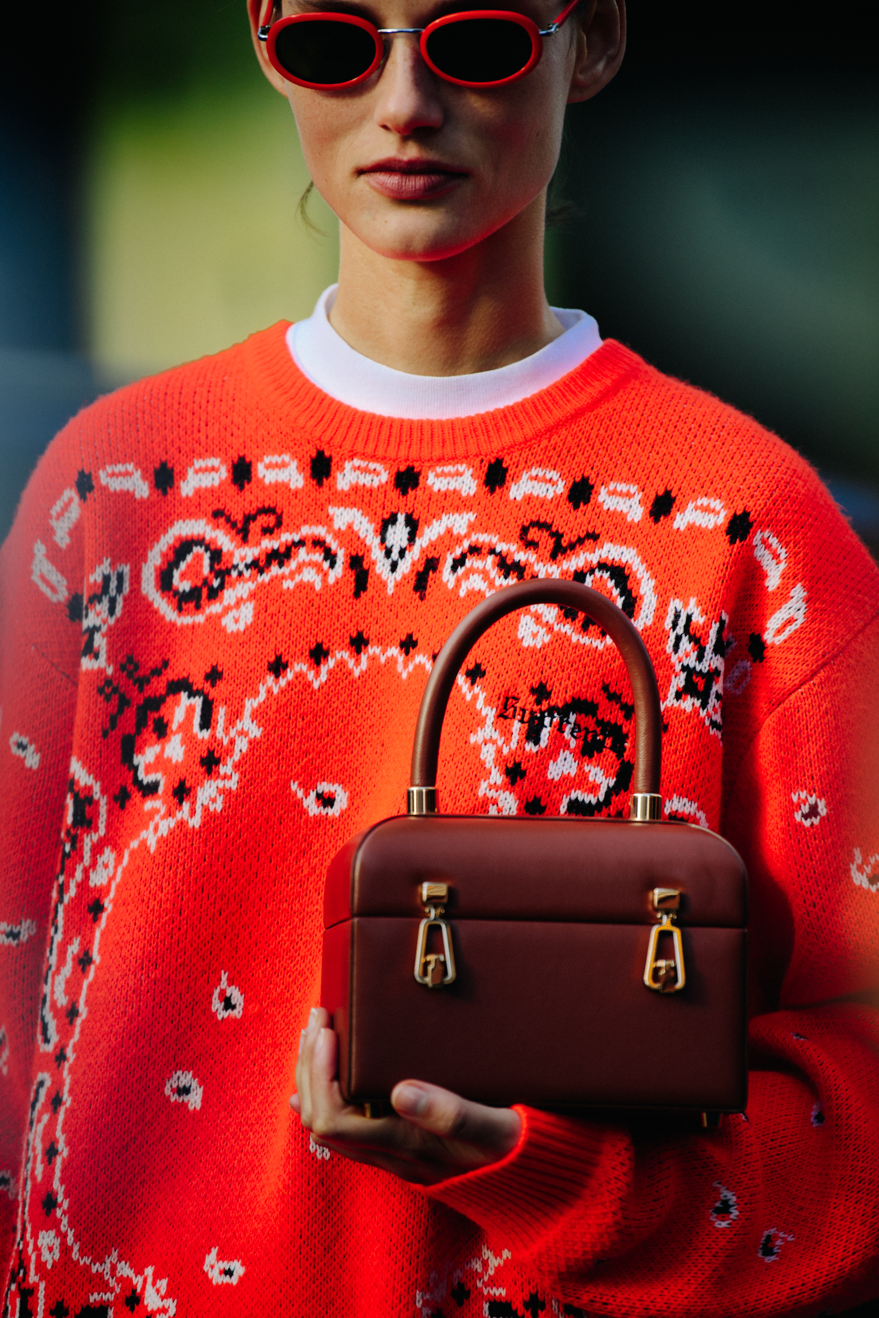 Model wearing orange jumper