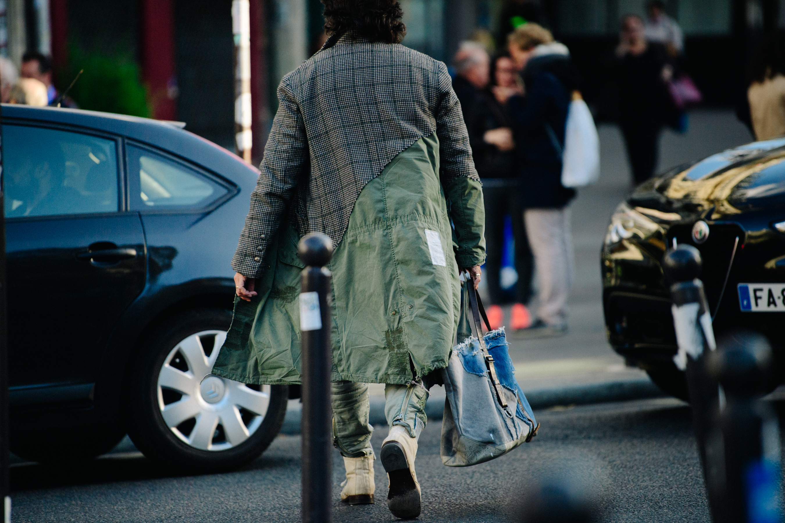 Man carrying denim bag