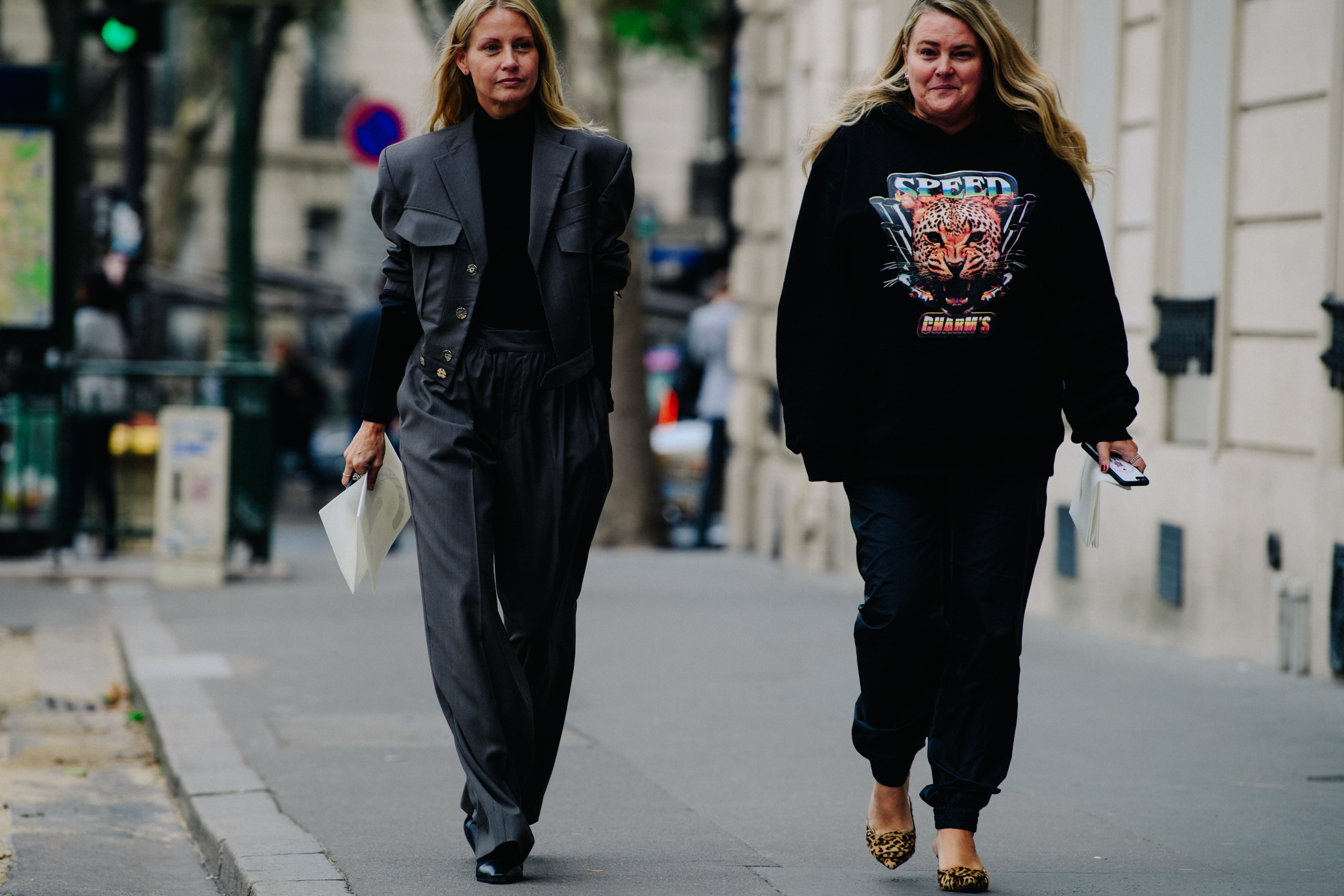 Two women wearing dark outfits