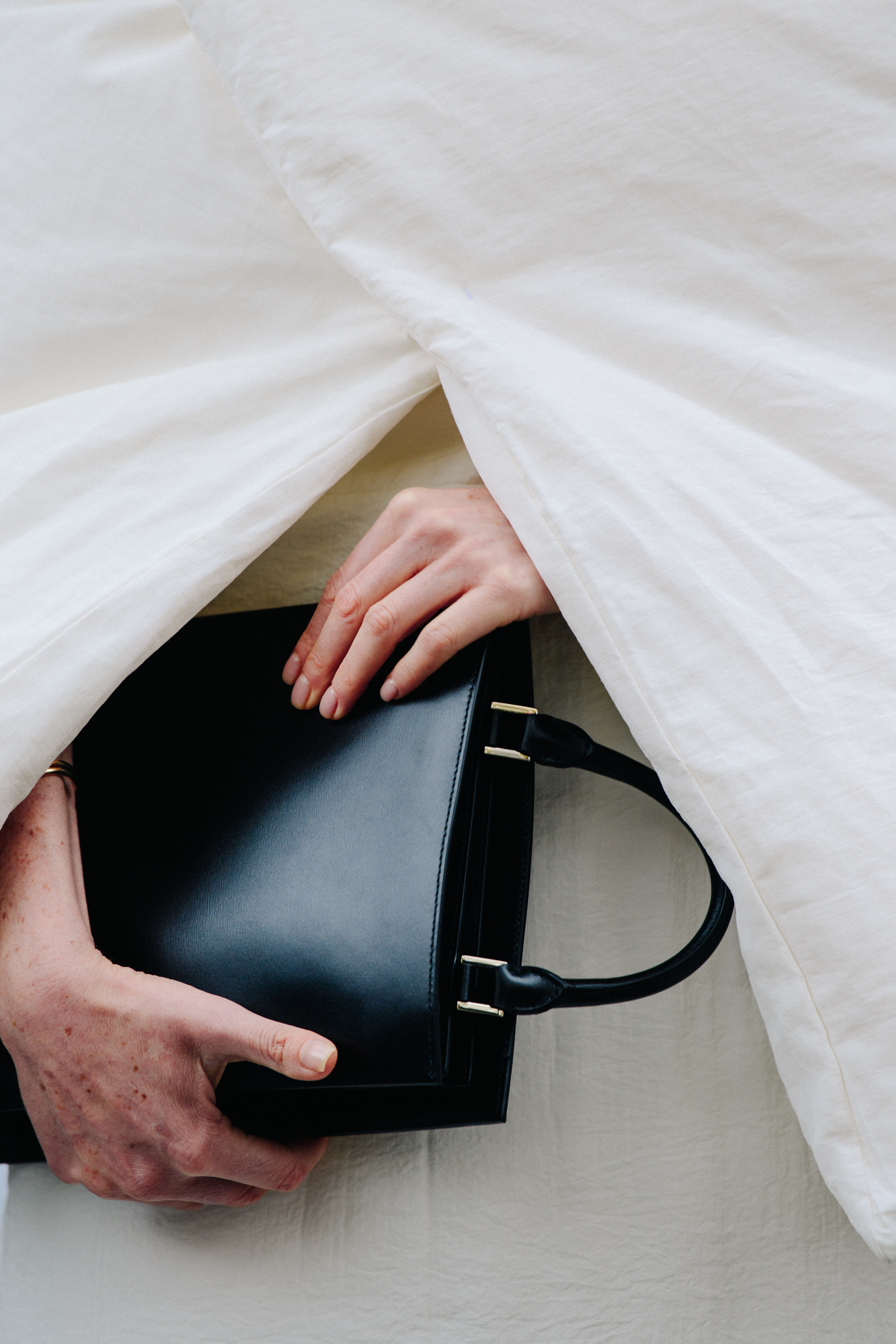 Woman carrying black leather bag