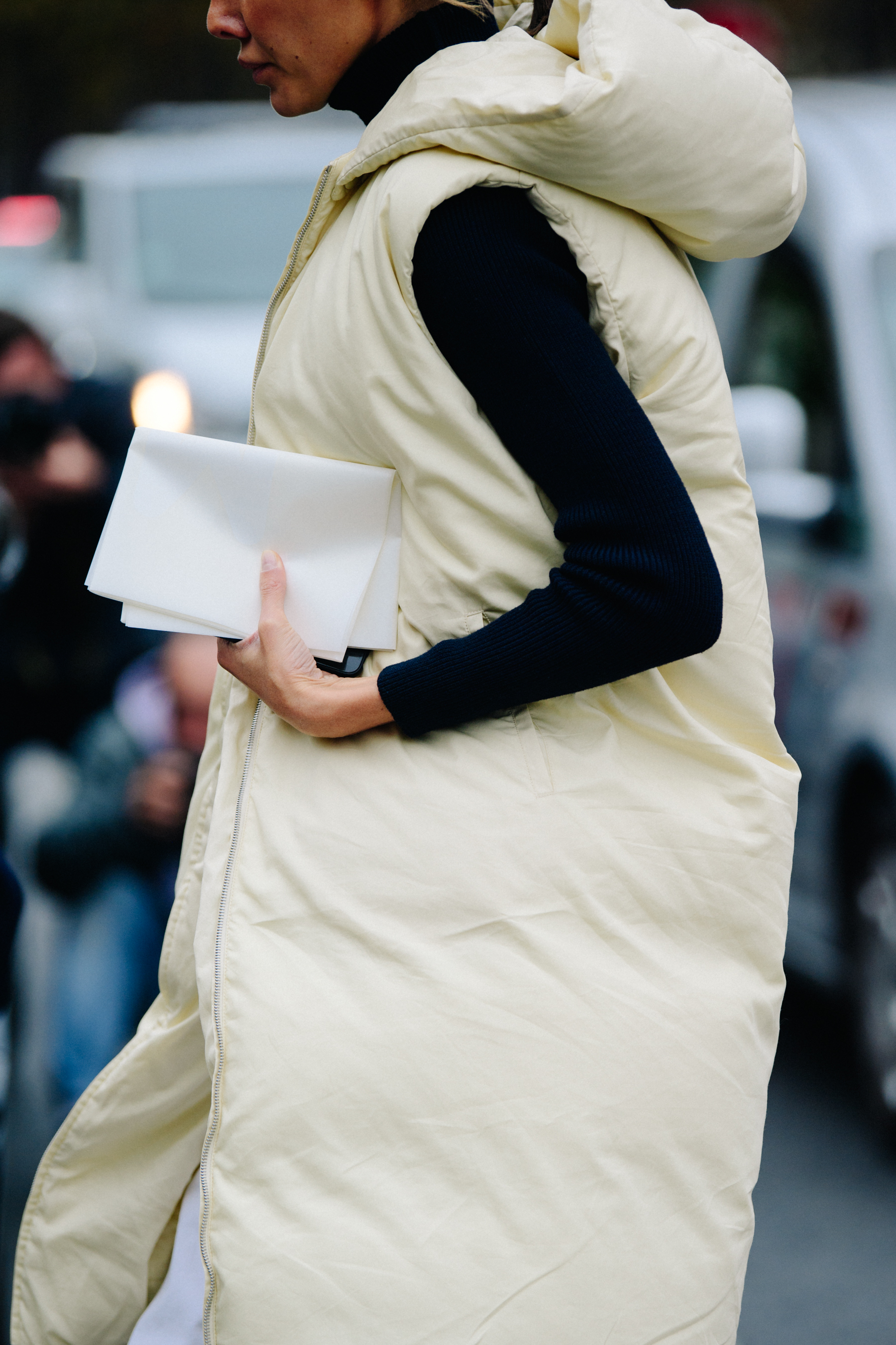Woman wearing long white vest