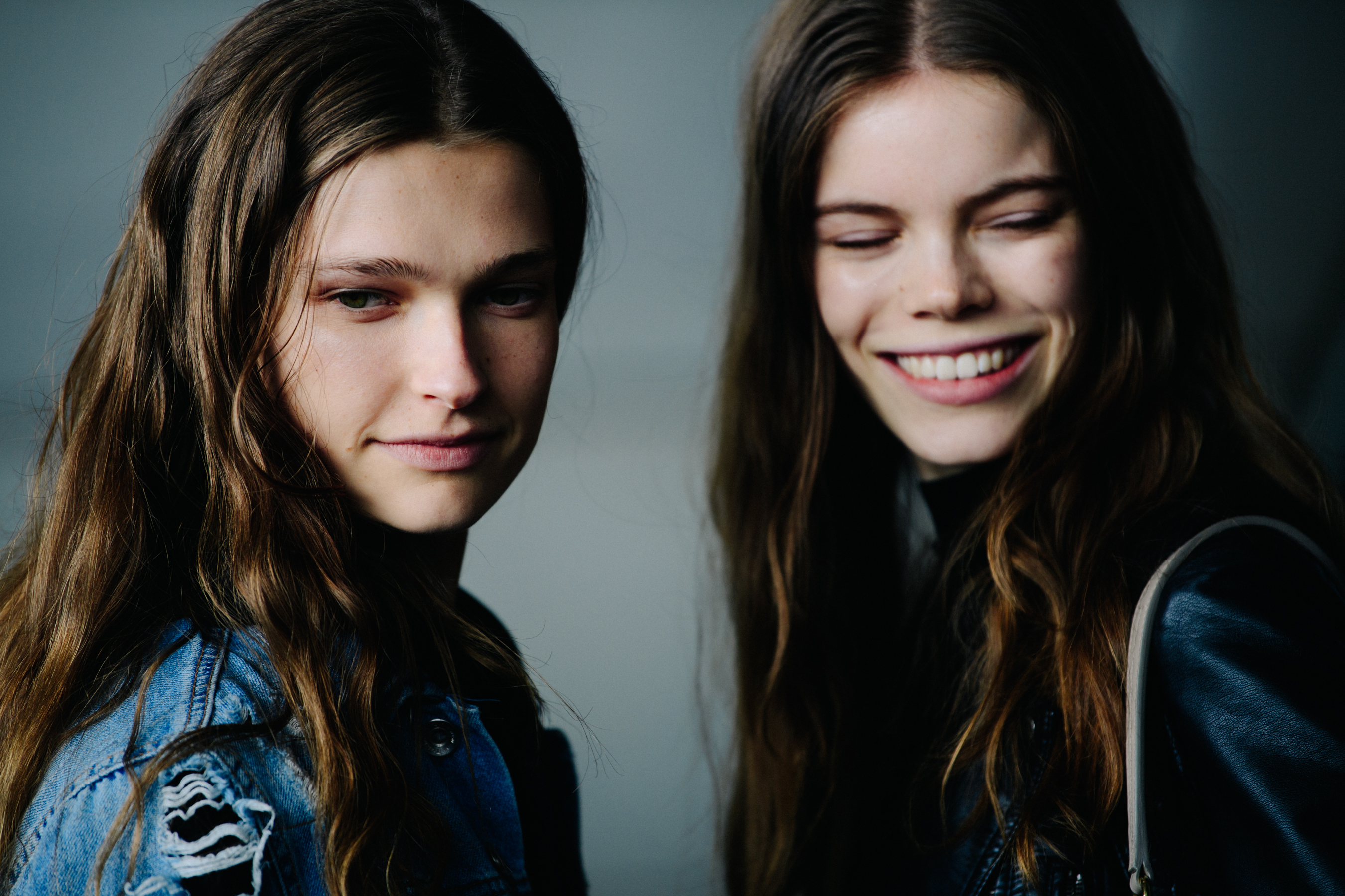 Two models with long brown hair