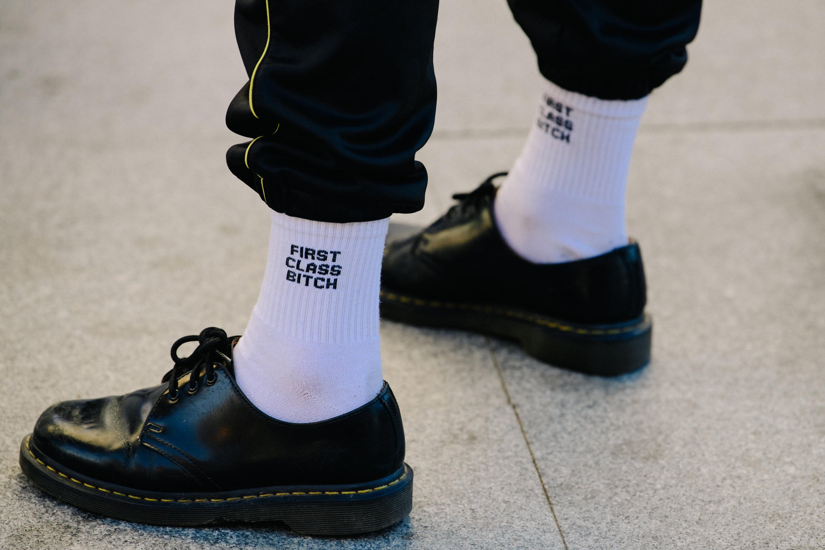 Man wearing black Dr Martens shoes