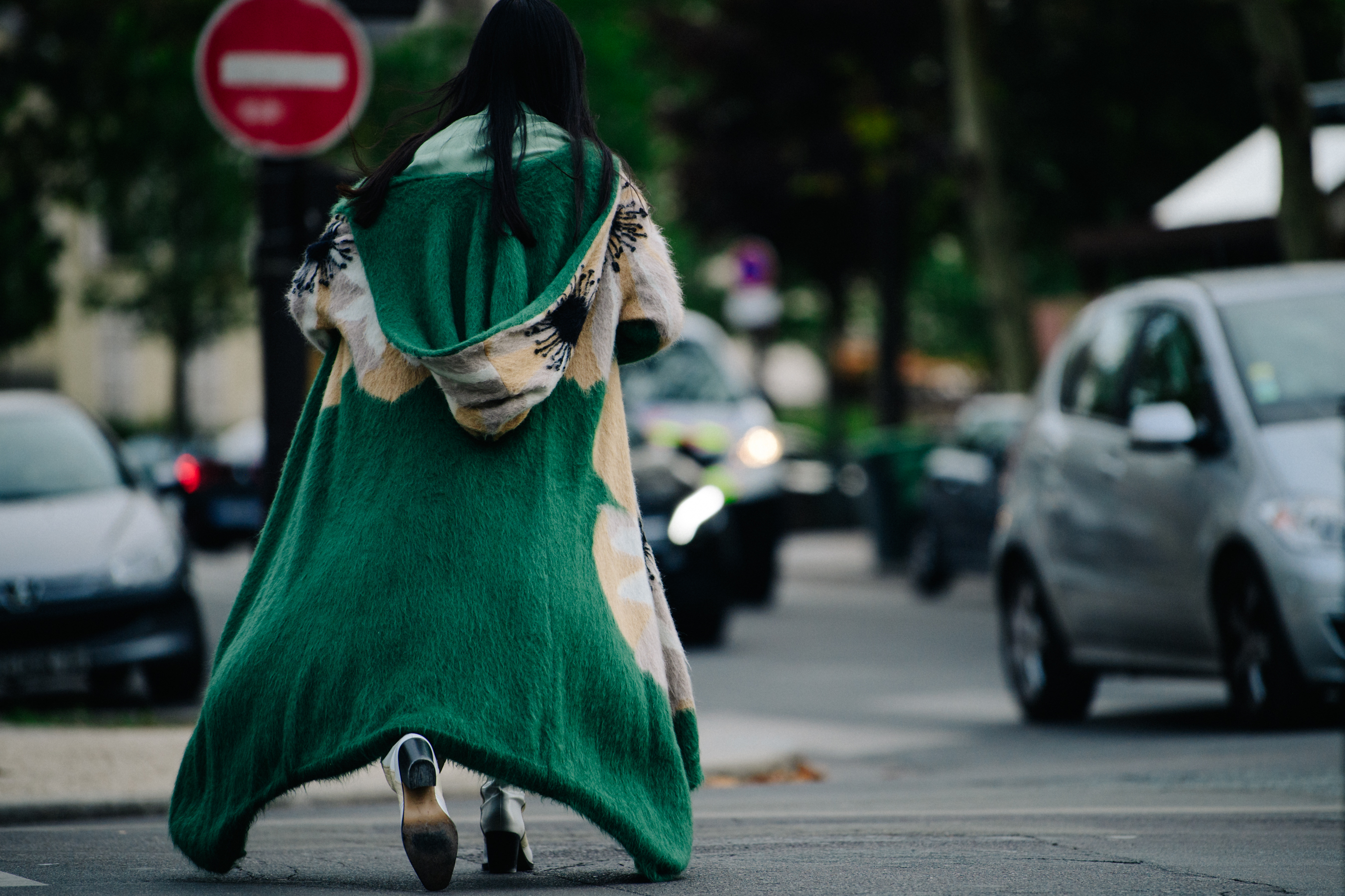 Woman wearing long green fur coat