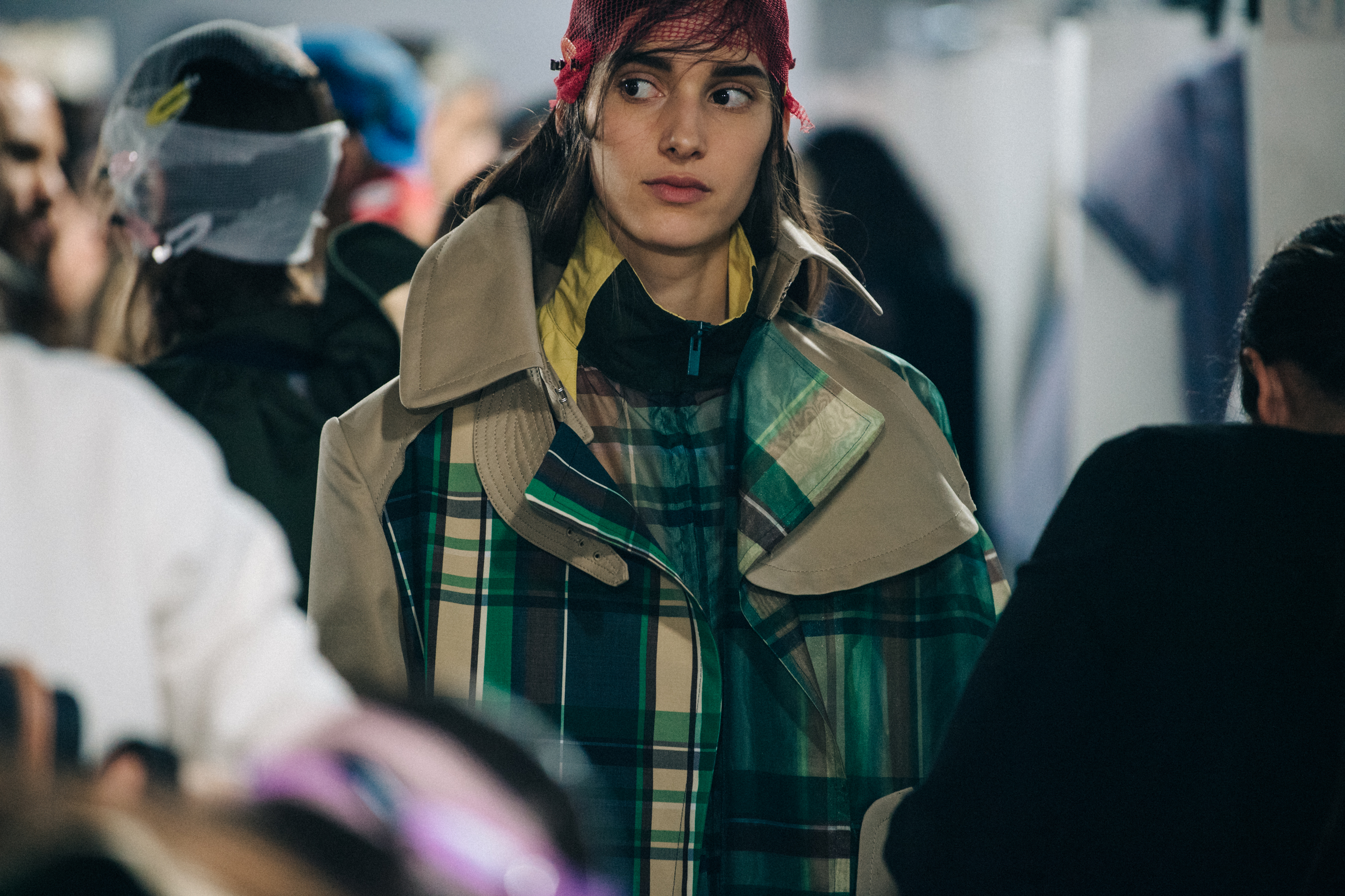Models wearing colourful Sacai outfits backstage