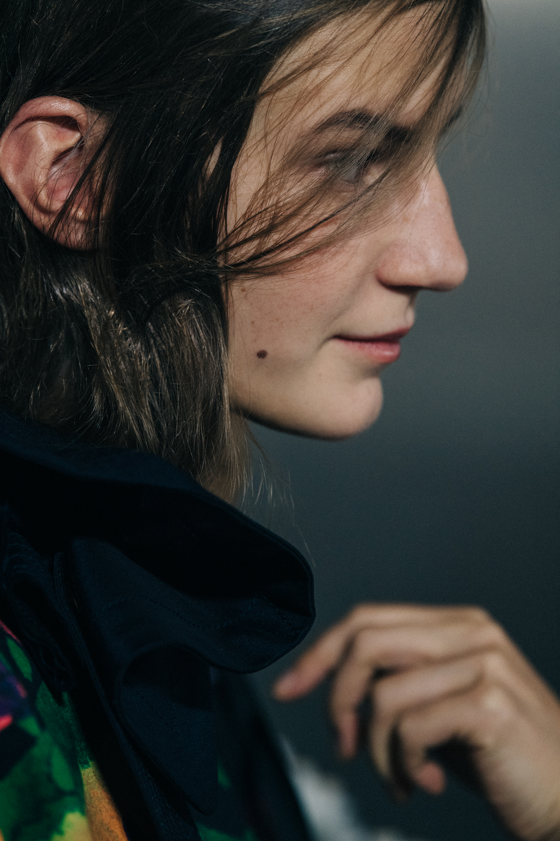 Models wearing colourful Sacai outfits backstage
