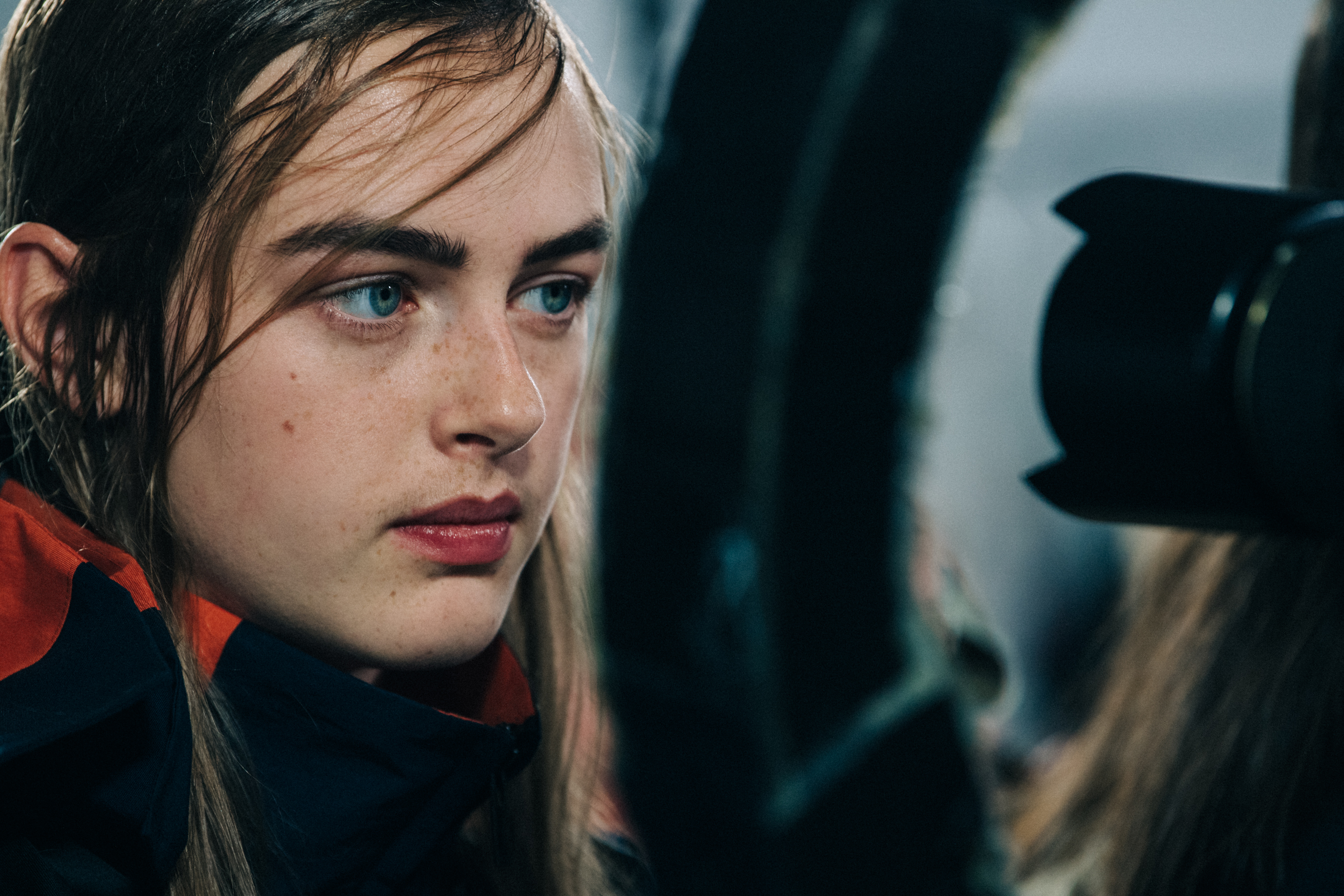 Models wearing colourful Sacai outfits backstage