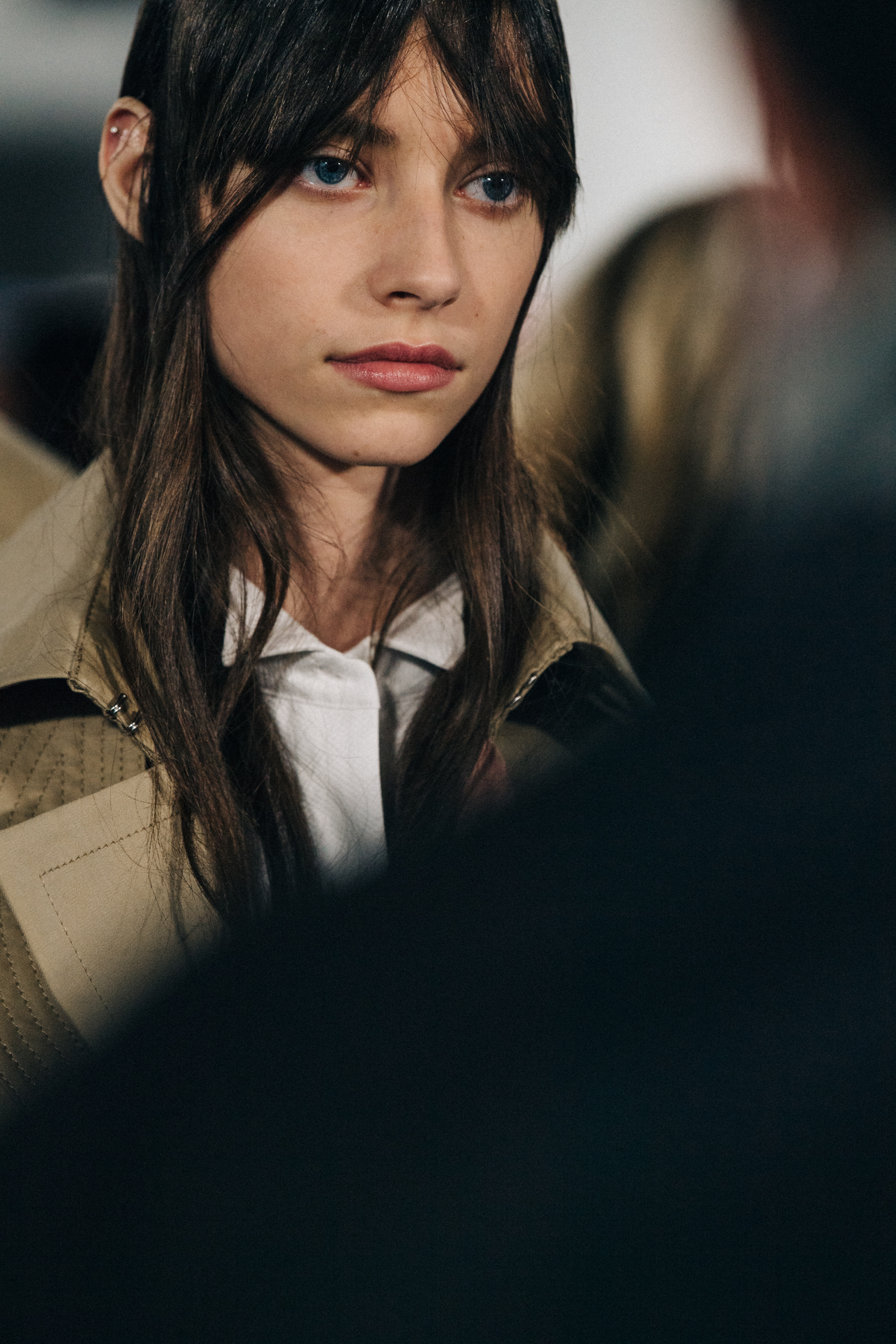 Models wearing colourful Sacai outfits backstage
