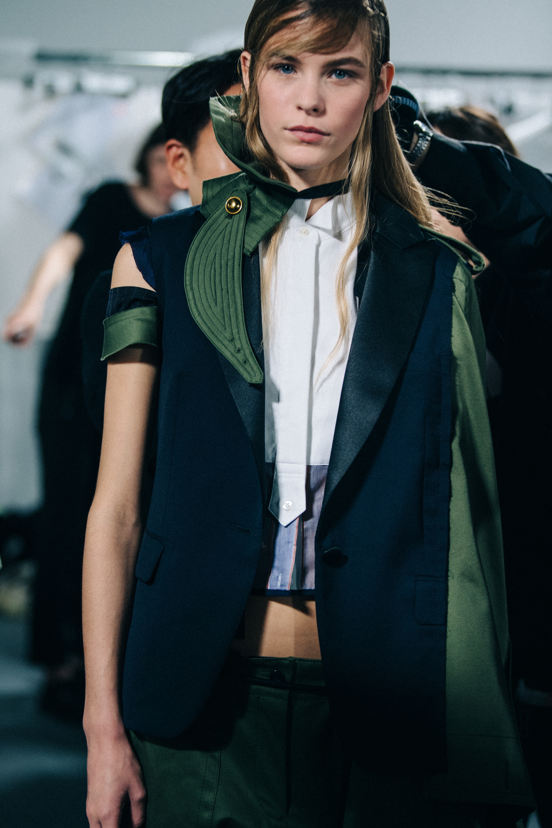 Models wearing colourful Sacai outfits backstage