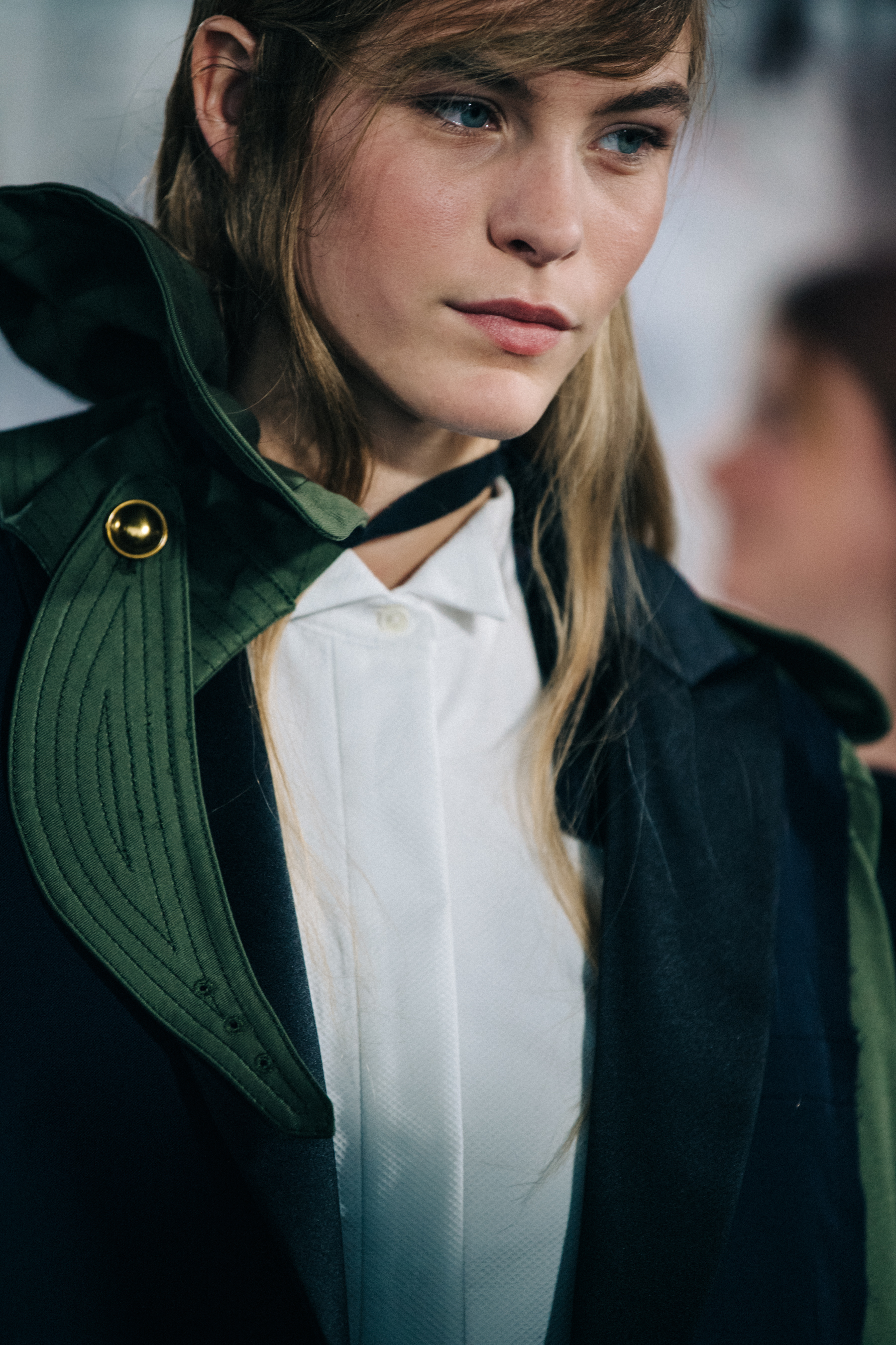 Models wearing colourful Sacai outfits backstage