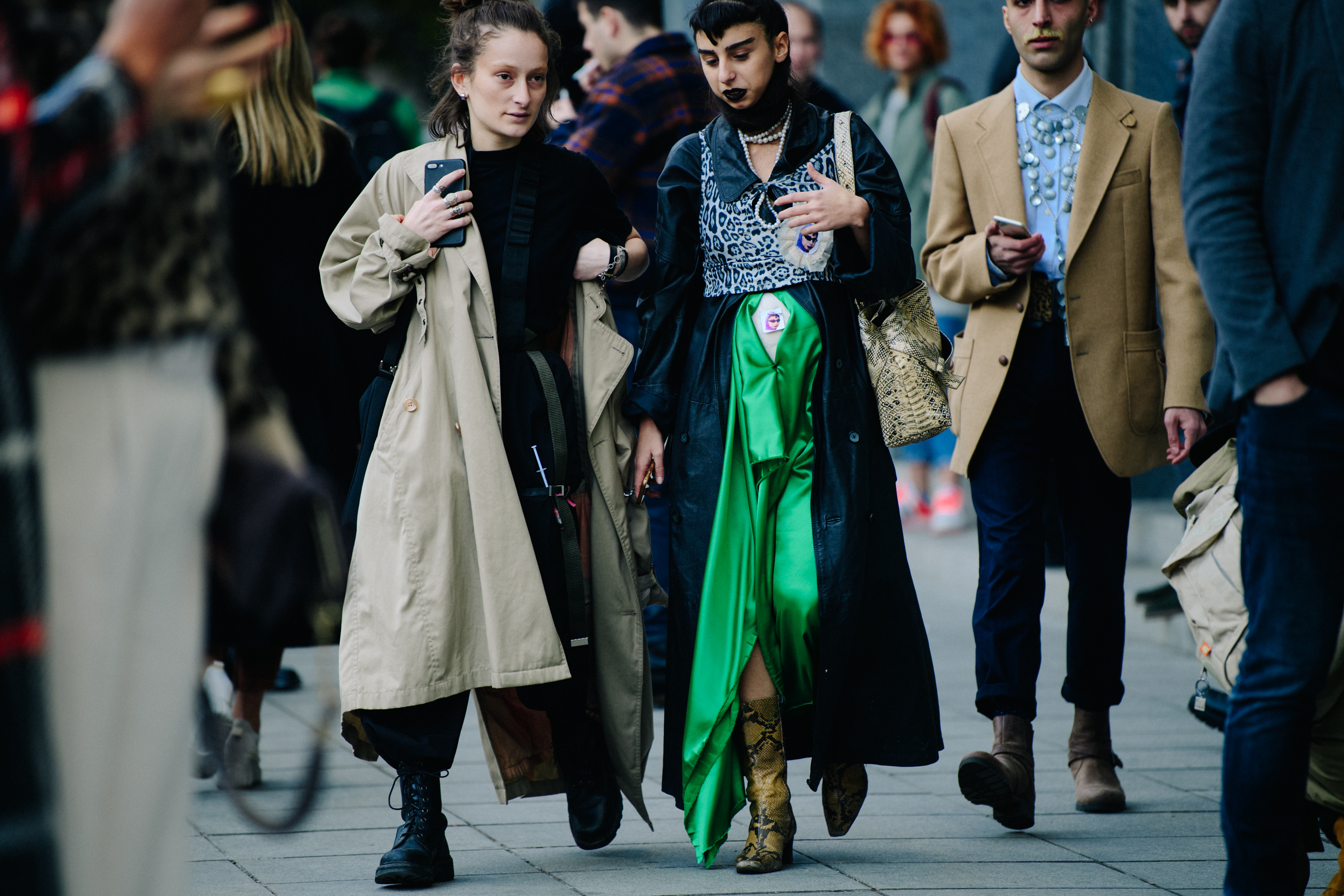 Two women wearing long coats