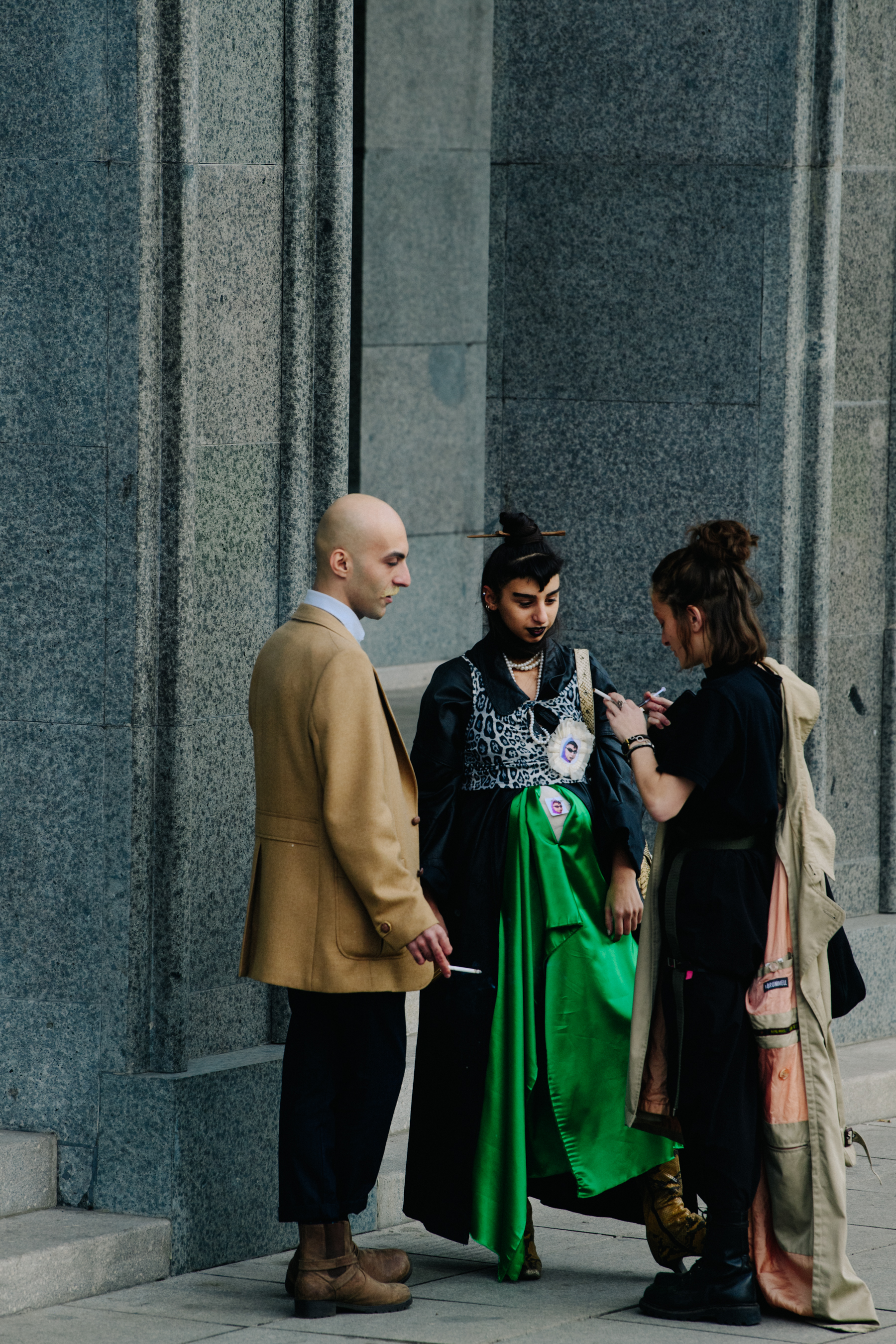 Three people wearing stylish outfits
