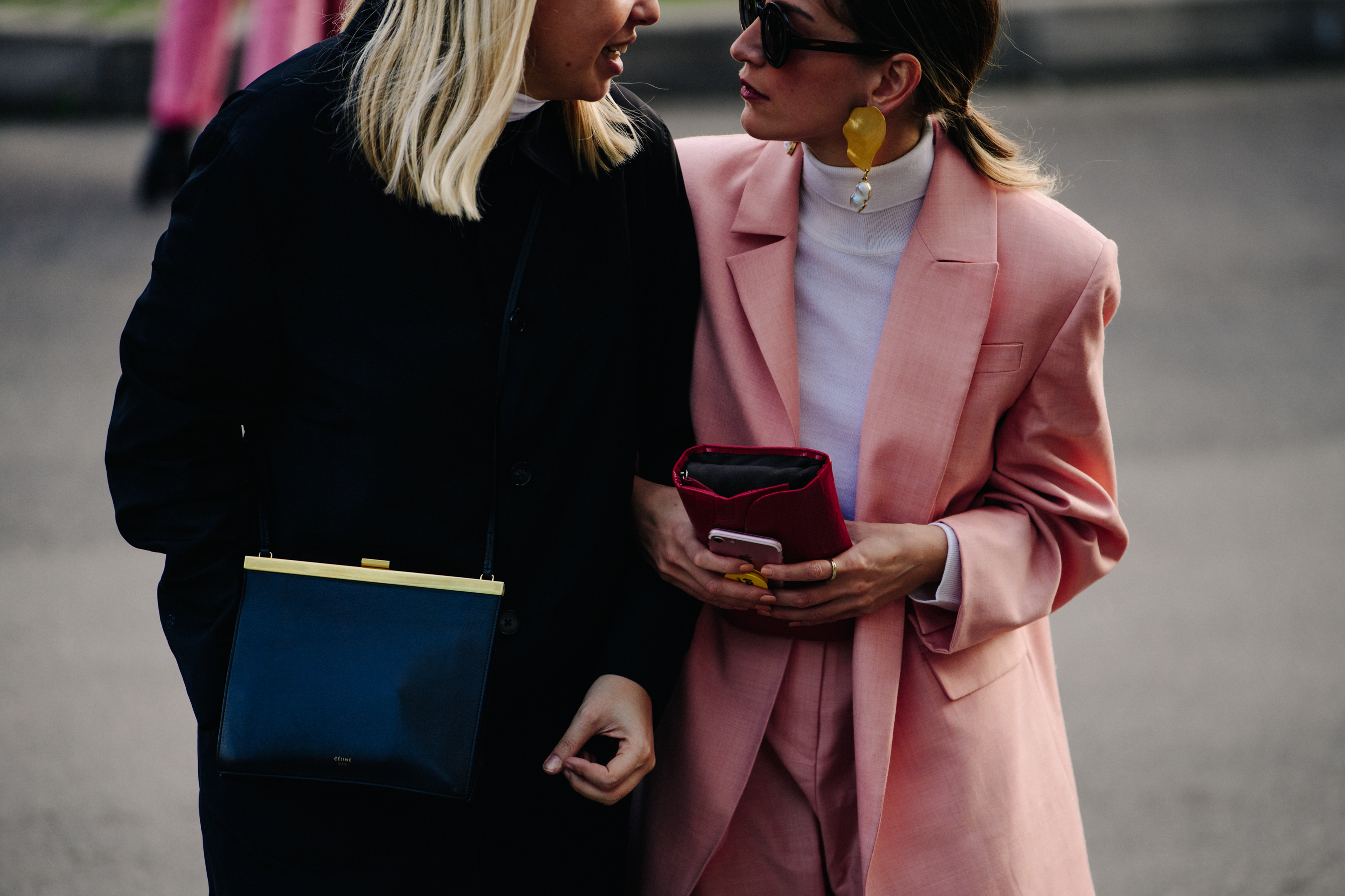 Two women carrying handbags