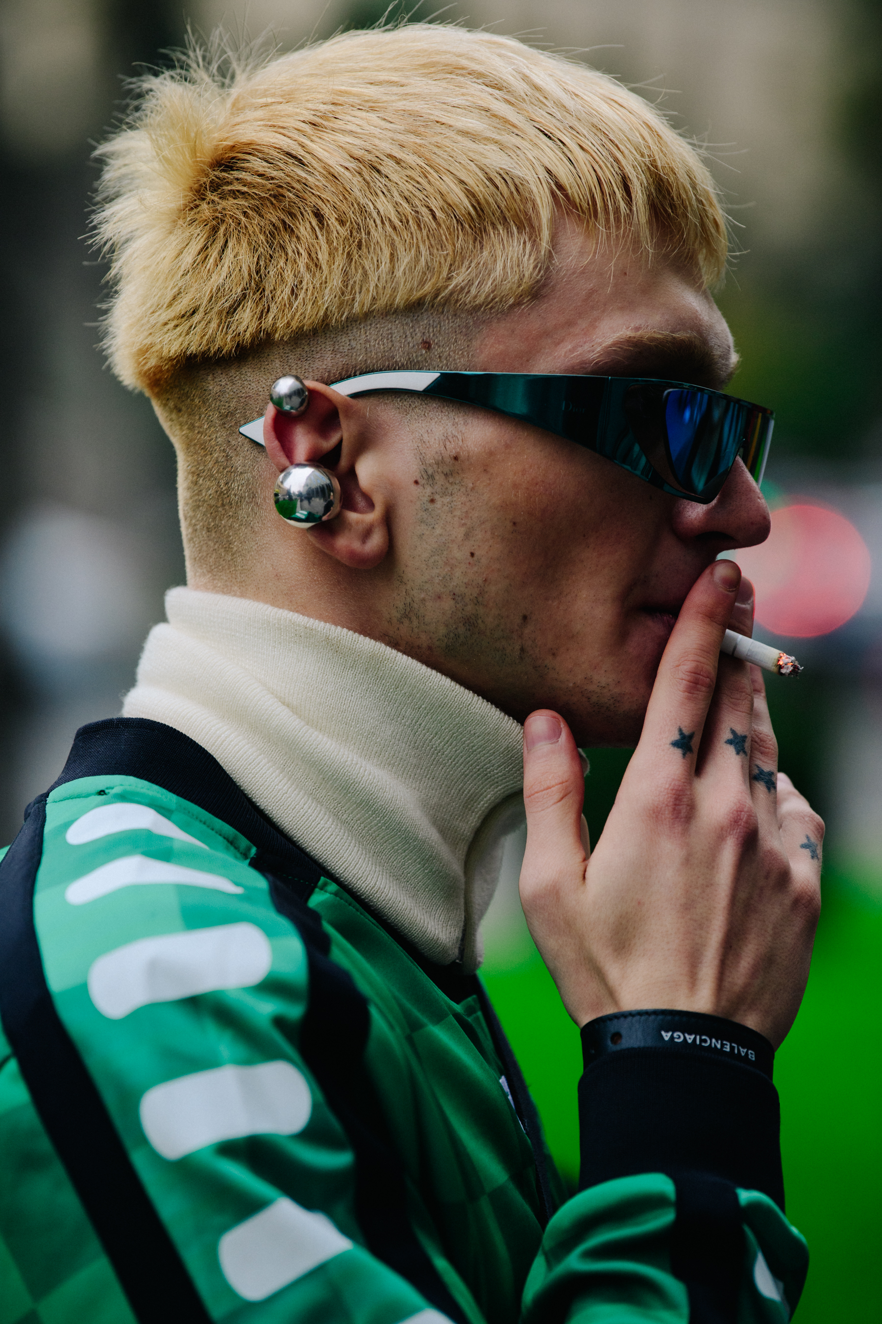 Man wearing green football shirt