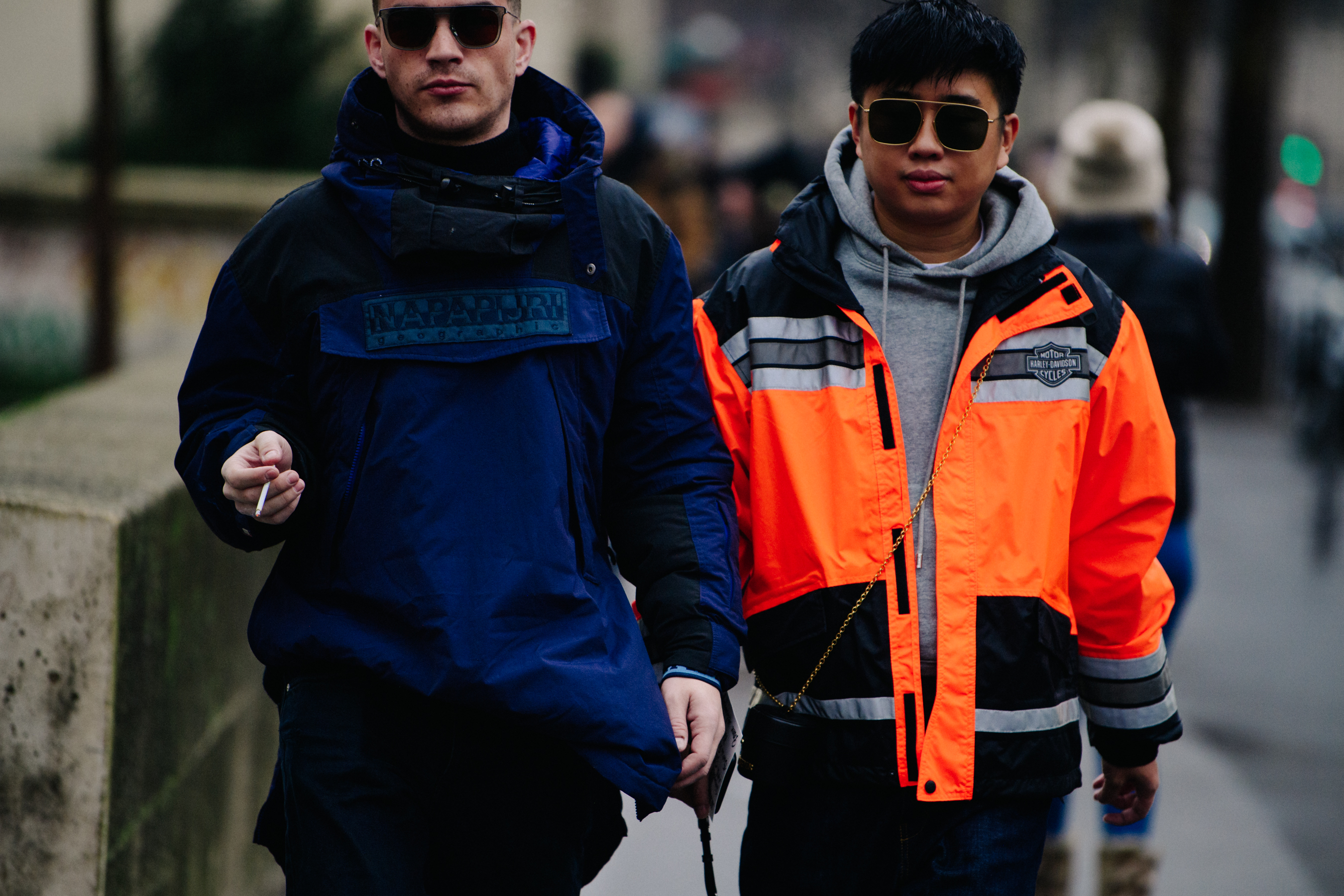 Two men wearing blue and orange