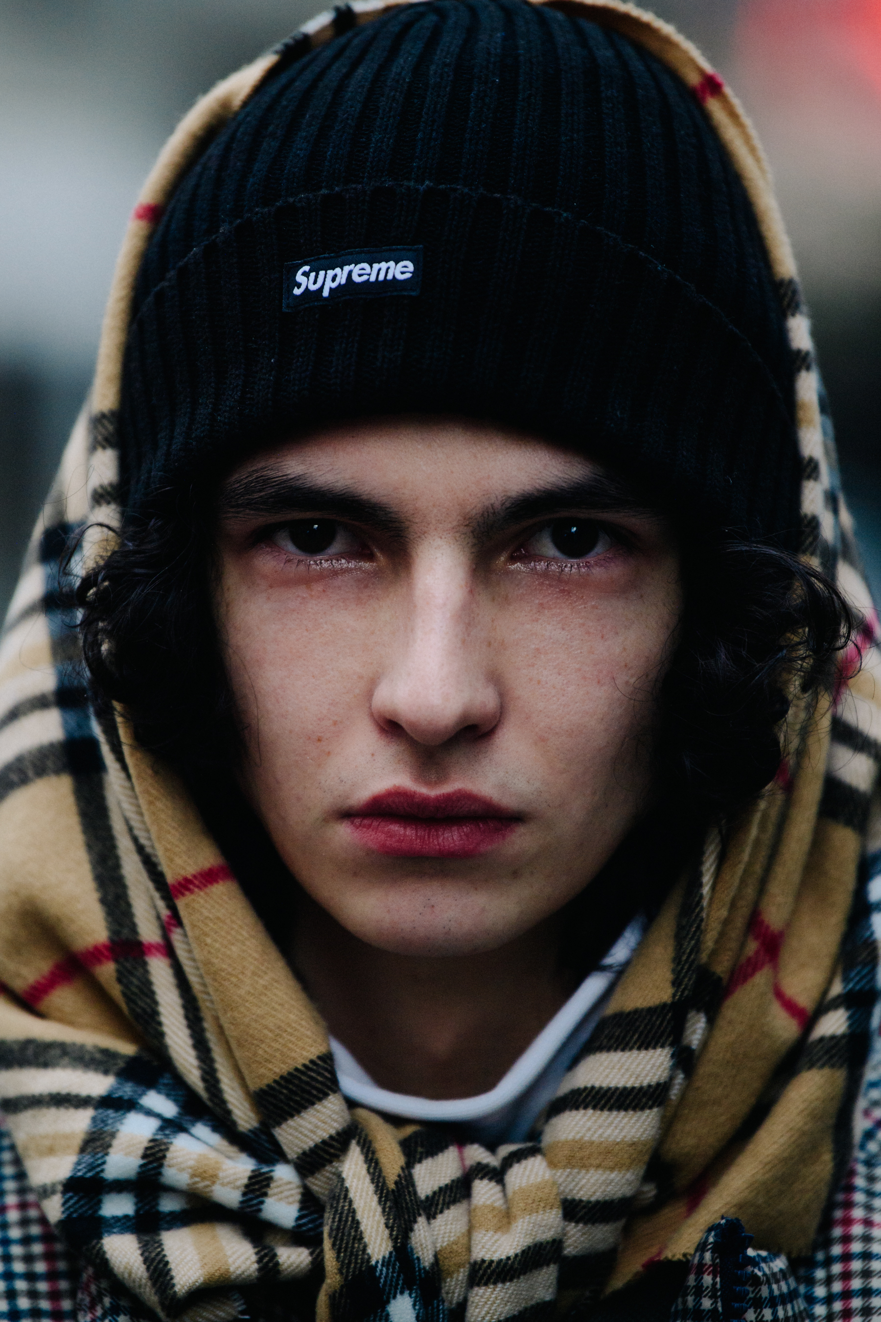 Portrait of model wearing Supreme beanie