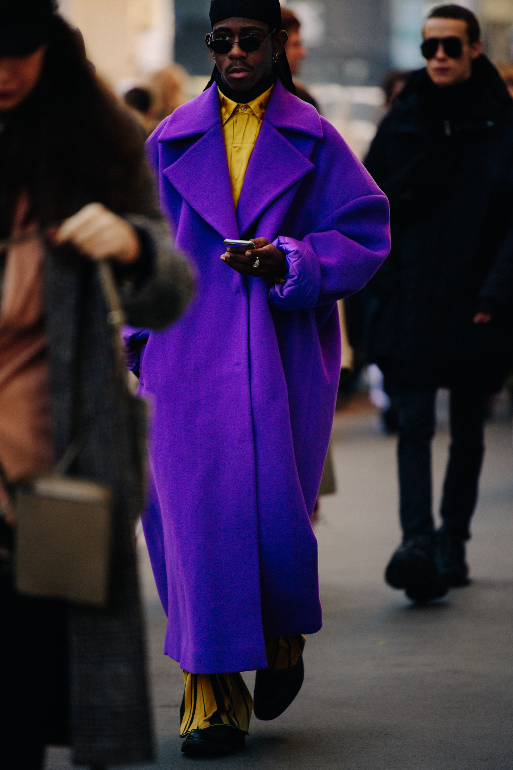 Man wearing long purple coat