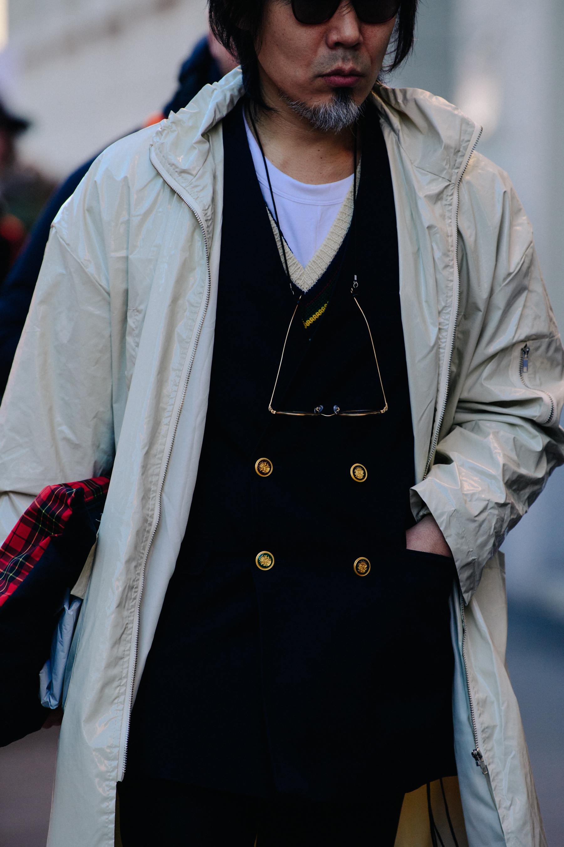Asian man wearing white coat