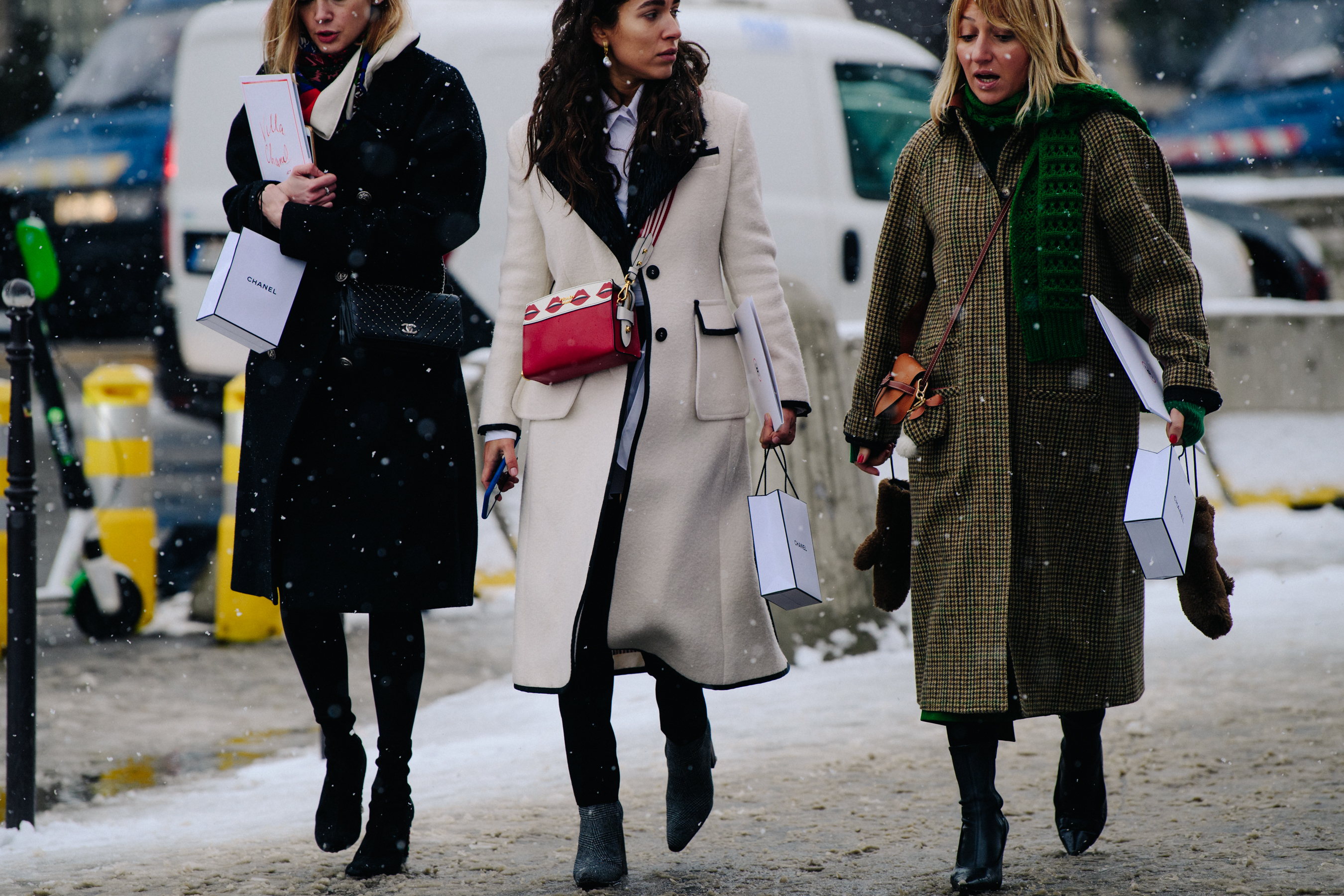 Three women wearing winter coats