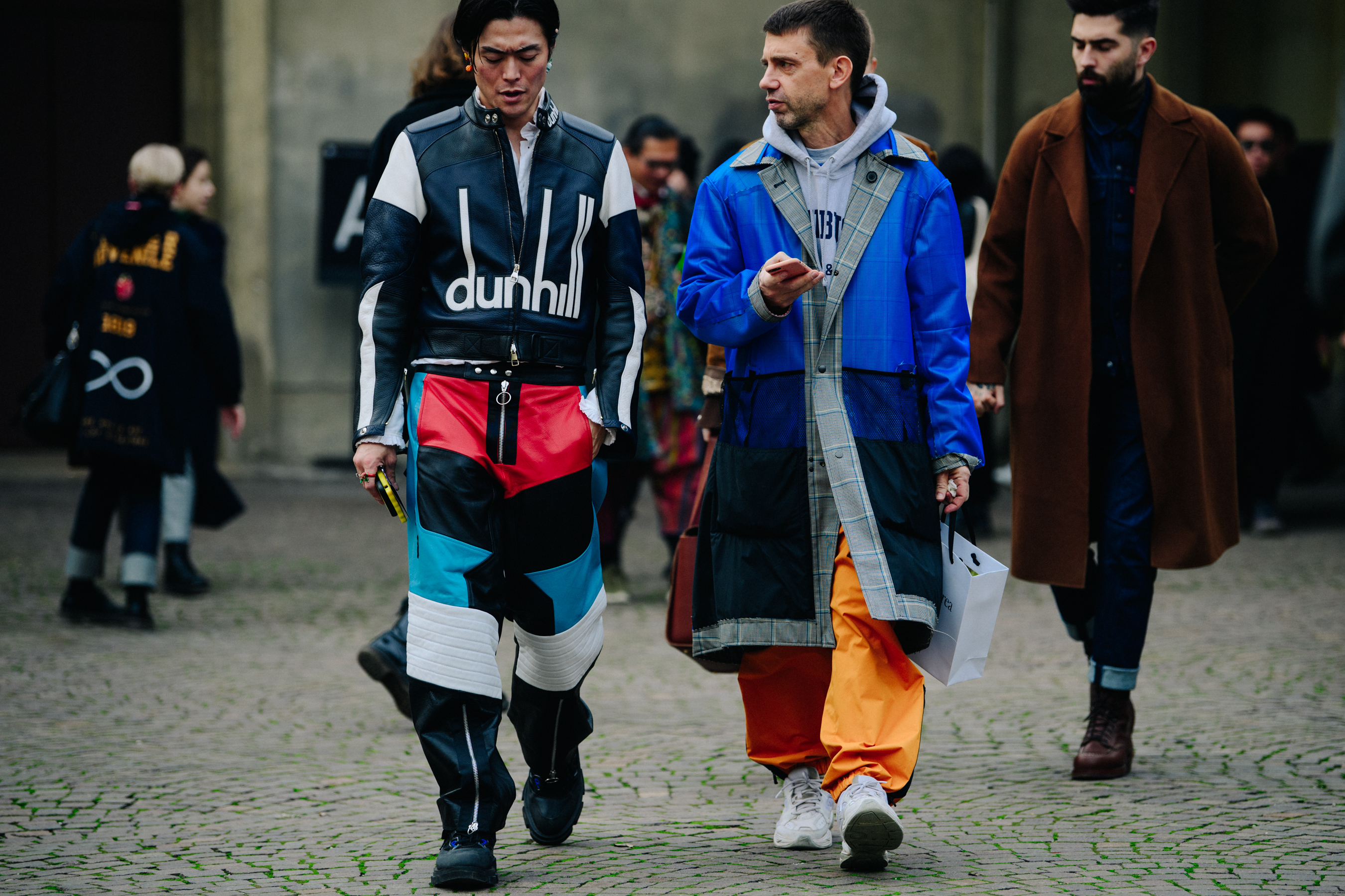 Two men wearing long blue outfits