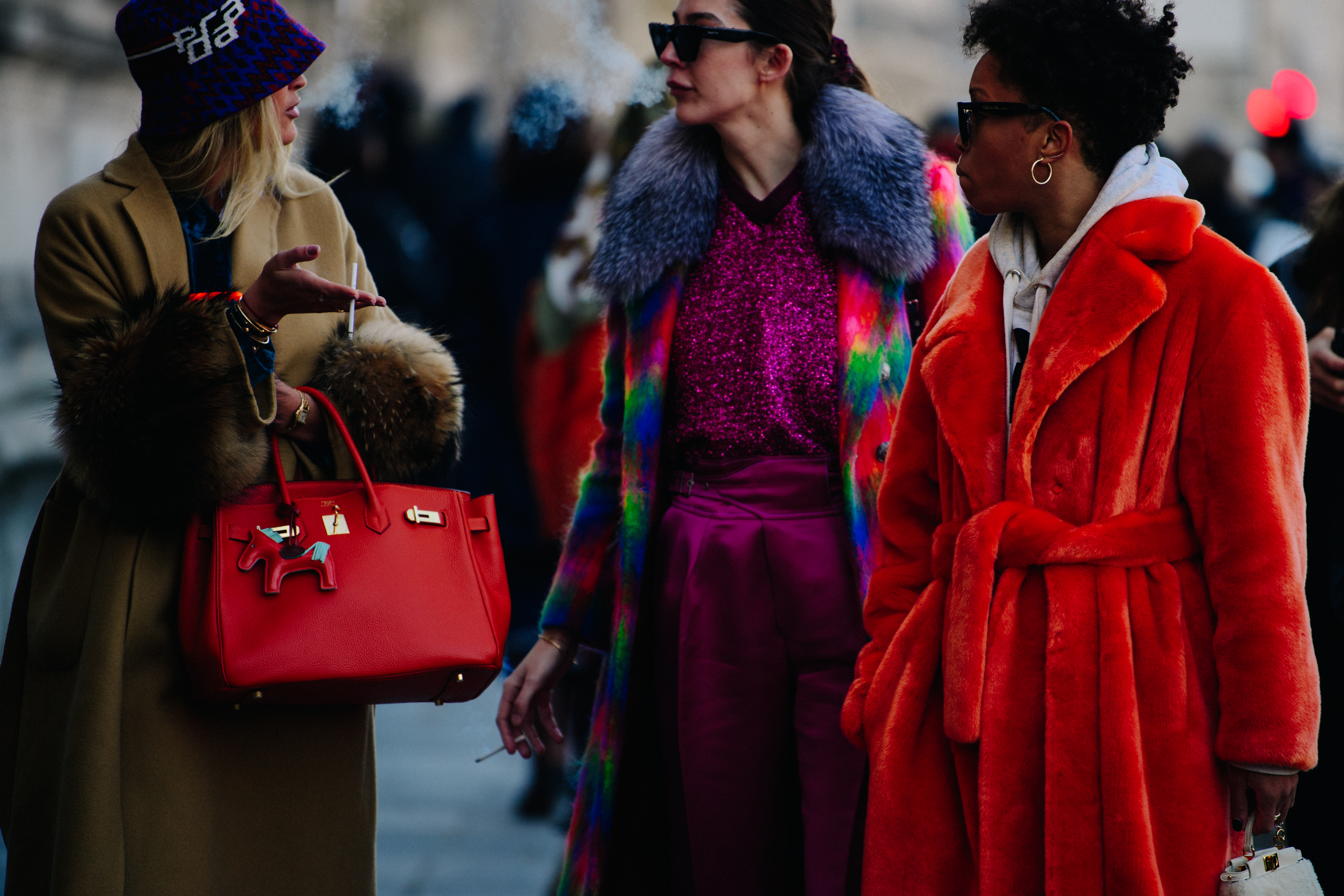 Three women wearing colourful clothing