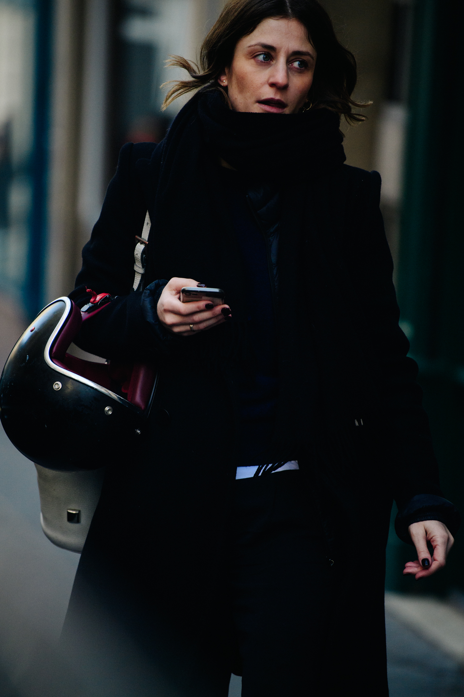 Woman carrying motorcycle helmet